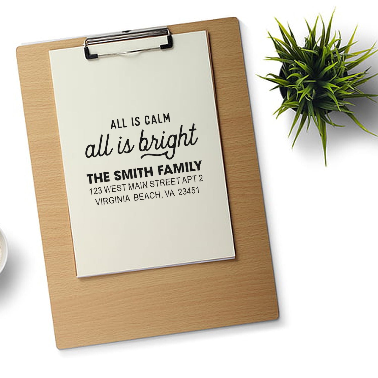 Personalized rubber address stamp with holiday greeting and family name for custom mailing cards and envelopes.