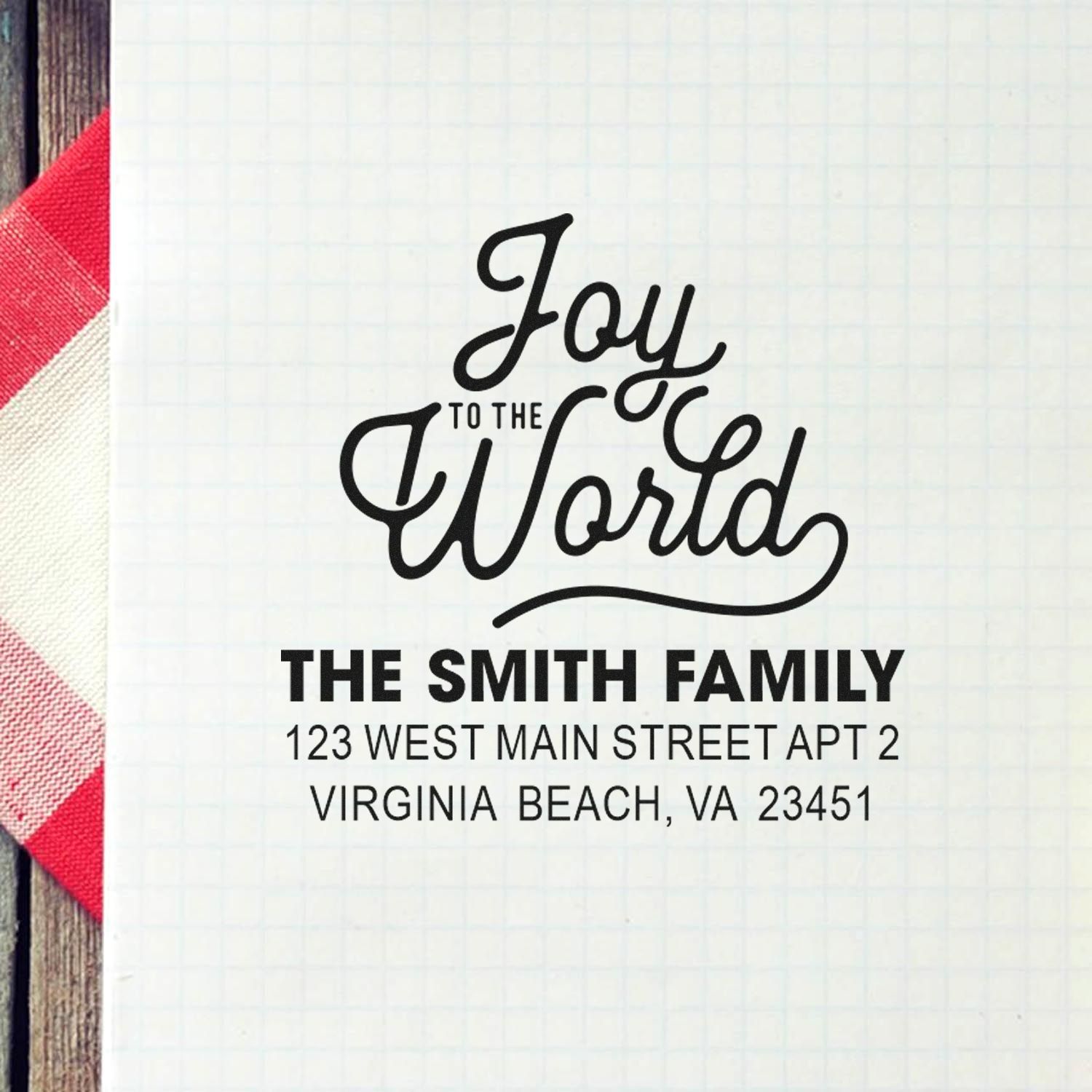 Custom return address rubber stamp with Joy to the World design and Smith family address for holiday mail.