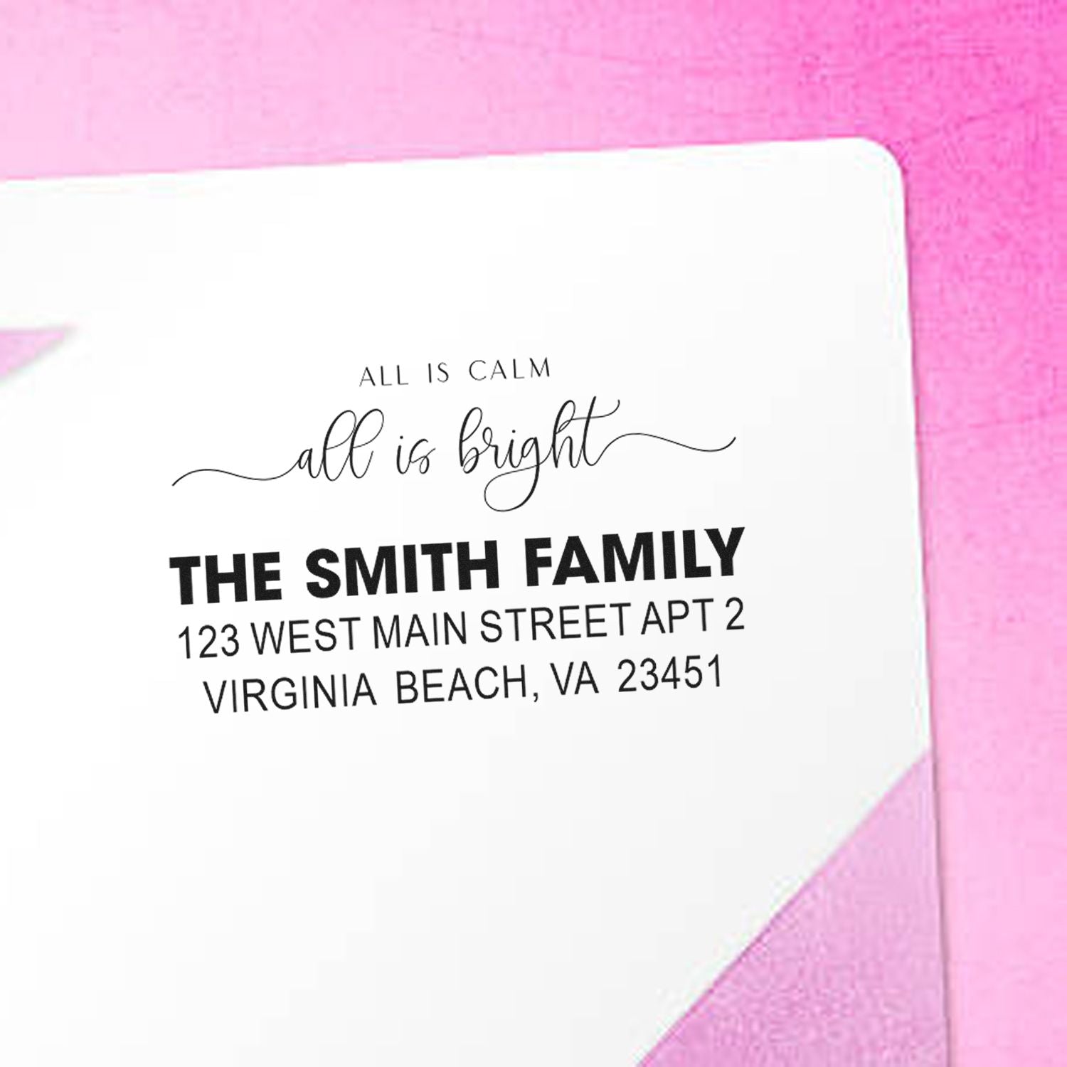 Custom return address rubber stamp on envelope featuring family name, slogan, and Virginia Beach address for holiday mail.