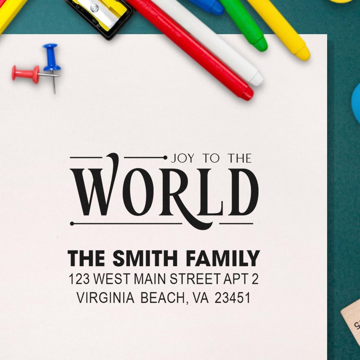 Personalized return address rubber stamp with Joy to the World and The Smith Family address imprint on paper