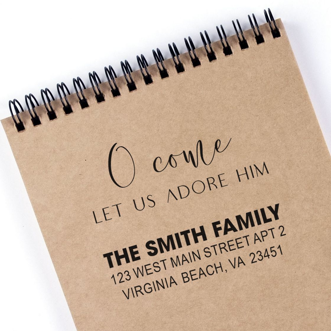 Custom rubber stamp sample with family return address and holiday message for personalized envelopes and stationery.