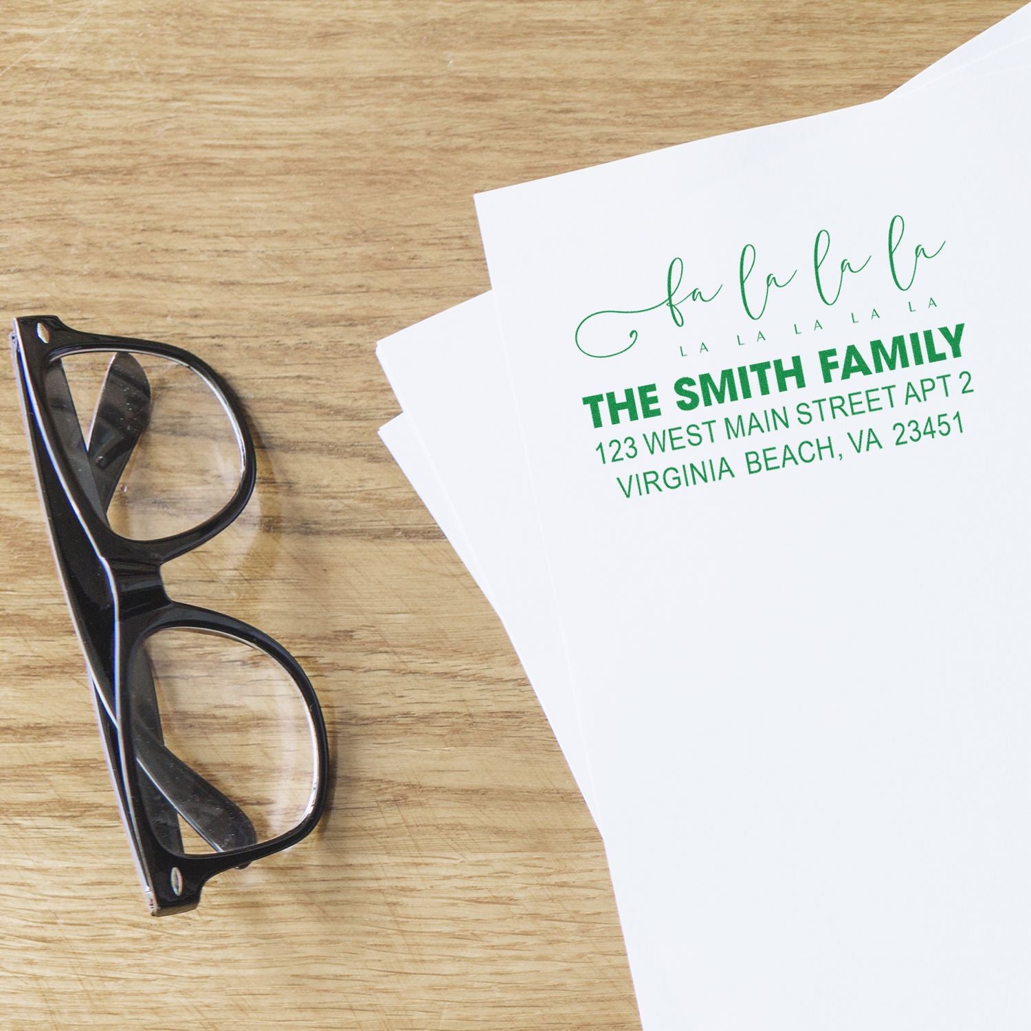 Personalized return address rubber stamp in green on envelopes, perfect for family mail and wedding stationery.