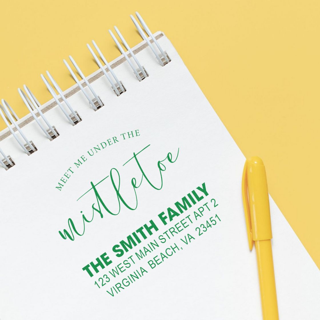 Personalized address rubber stamp design on notebook with Meet Me Under the Mistletoe holiday greeting and The Smith Family address.