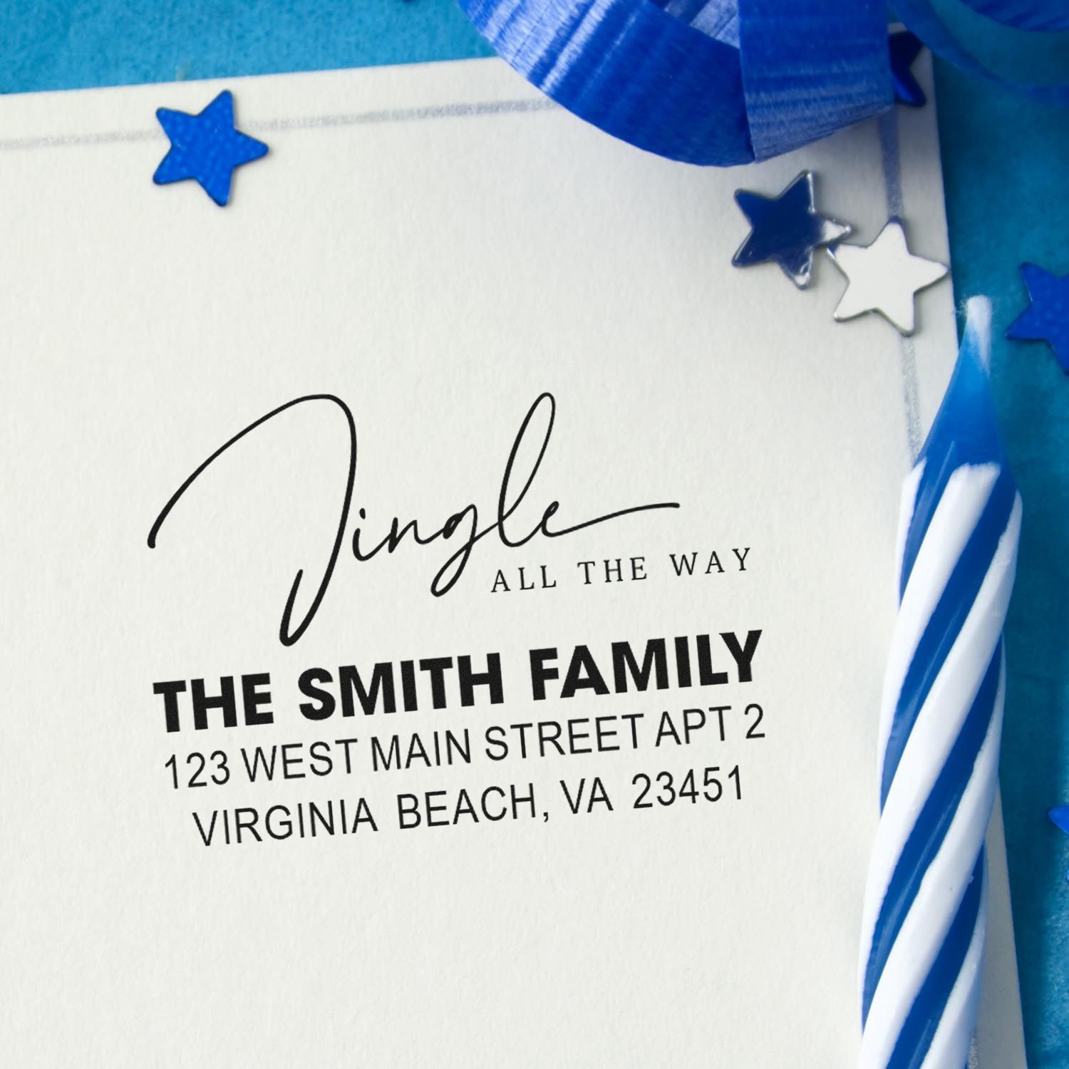 Personalized return address rubber stamp with family name, address, and festive blue ribbon and stars