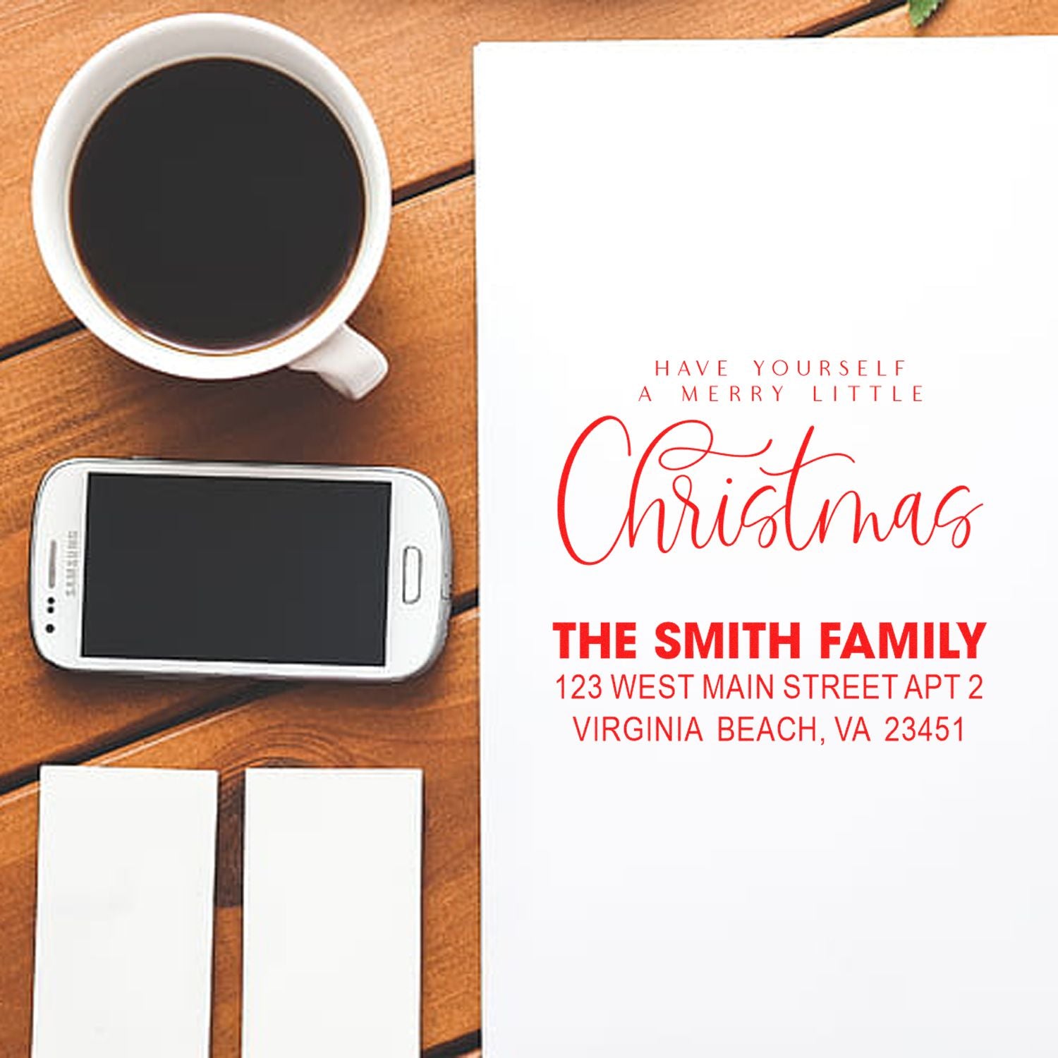 Personalized Christmas rubber stamp for holiday cards, featuring family name and return address on a festive card mockup.
