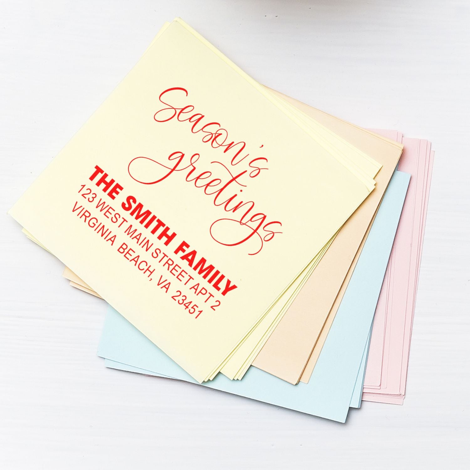 Custom holiday rubber stamp with Seasons Greetings and return address for personalized cards.