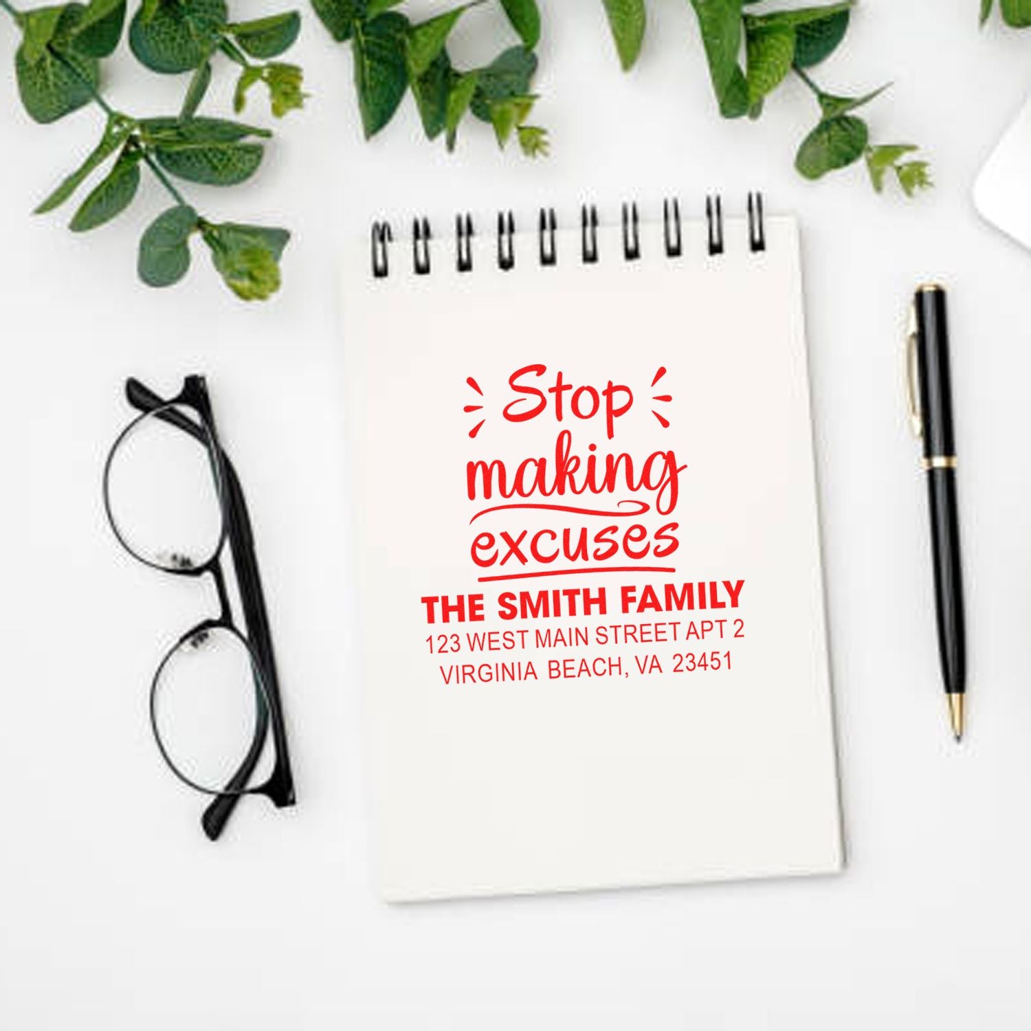 Personalized family return address rubber stamp with Stop making excuses design on a notebook mockup.