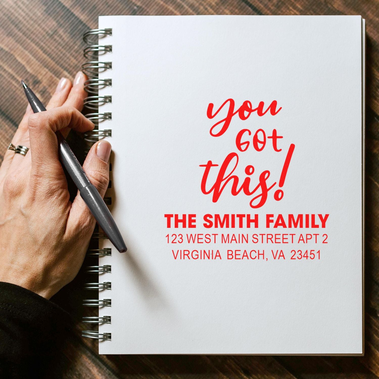 Custom rubber stamp reading you got this! with The Smith Family return address on a notebook page.
