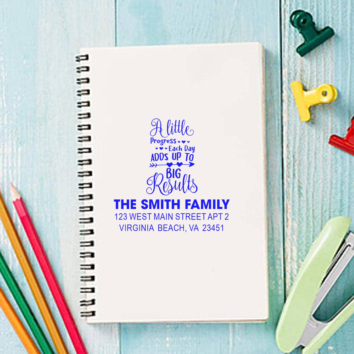 Custom family address rubber stamp on notebook with The Smith Family personalized return address and quote design.