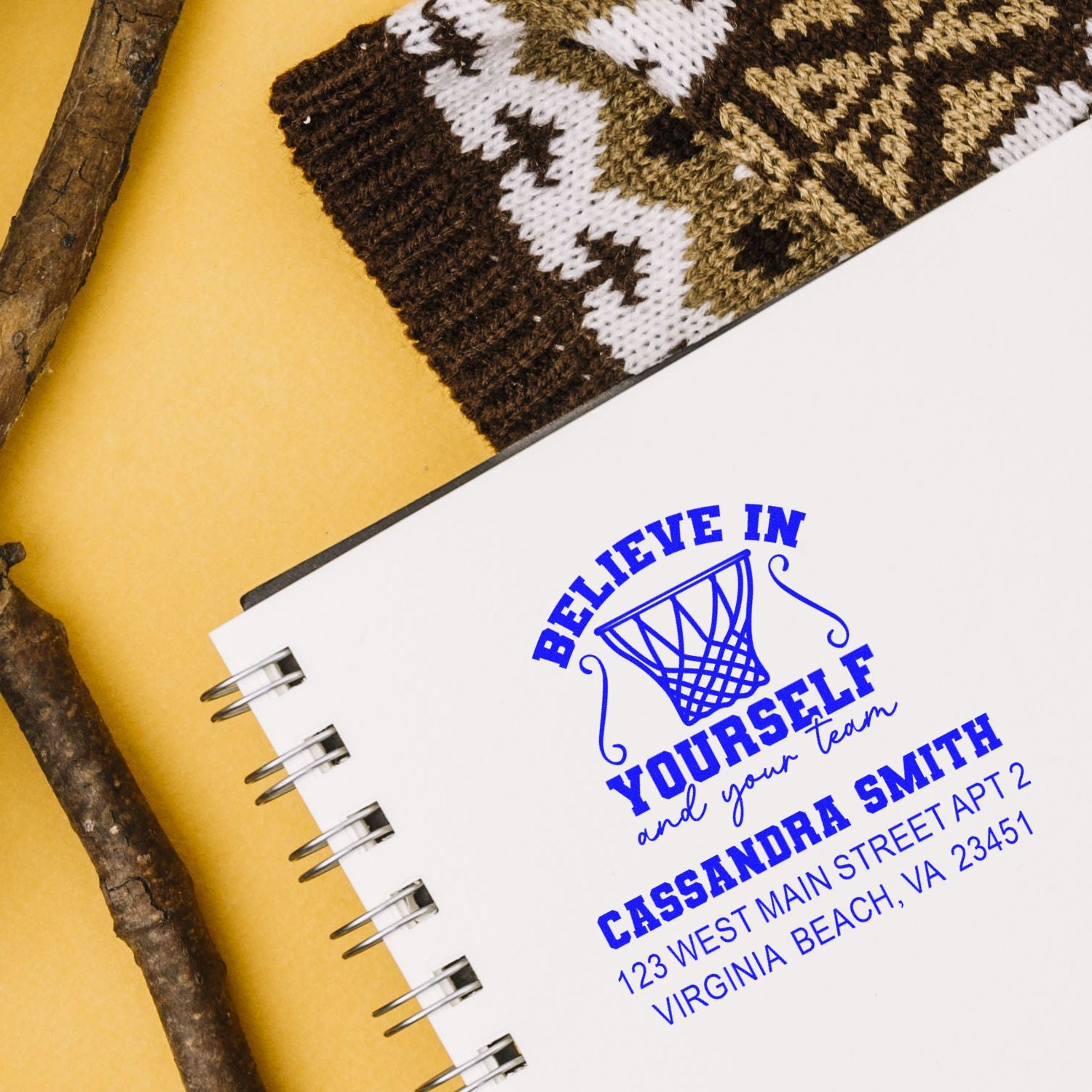 Custom rubber stamp on notebook with basketball design and return address, featuring Believe in yourself and your team message.