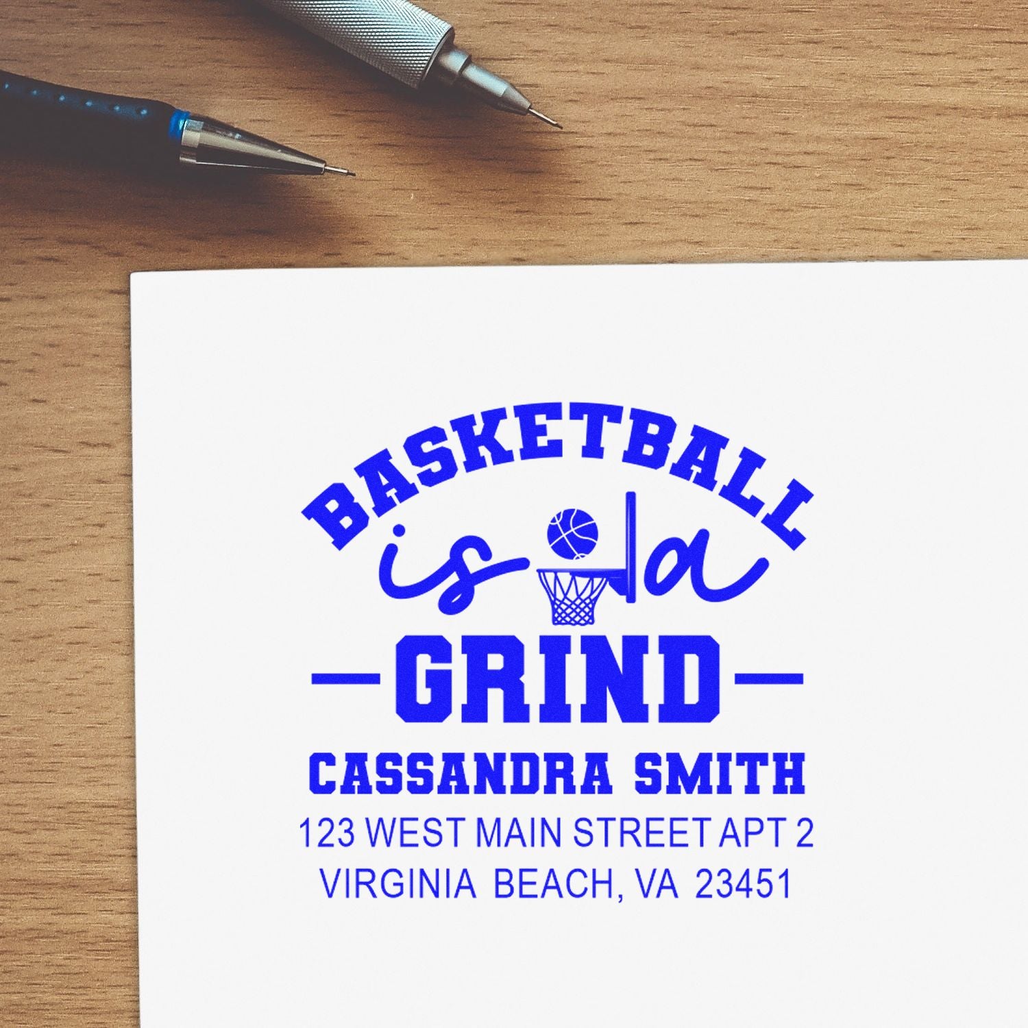 Custom basketball rubber stamp reading Basketball Is a Grind with name and address for personalized stationery.