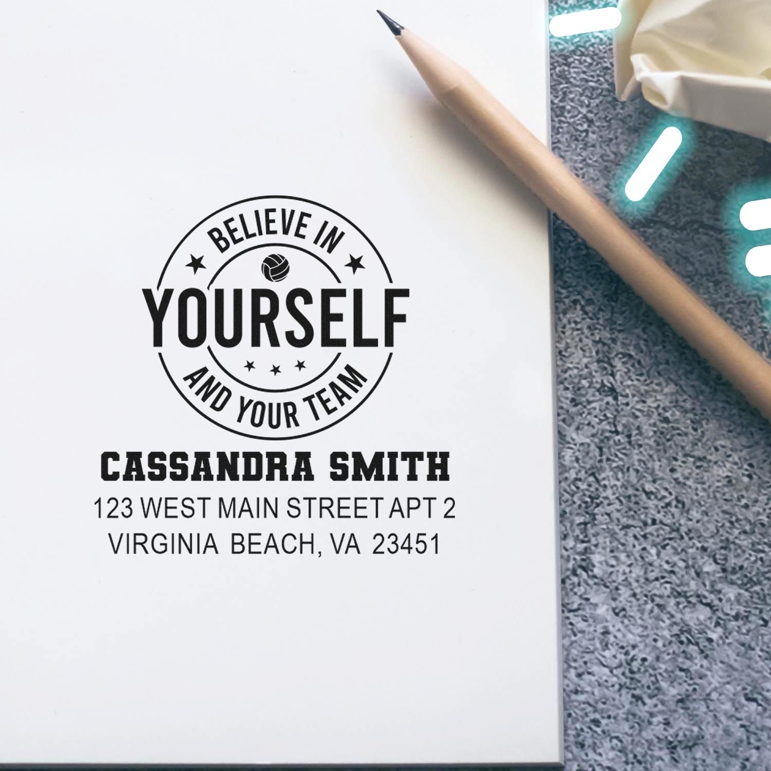 Custom rubber stamp impression with motivational logo, name, and address for business mailings and team branding.
