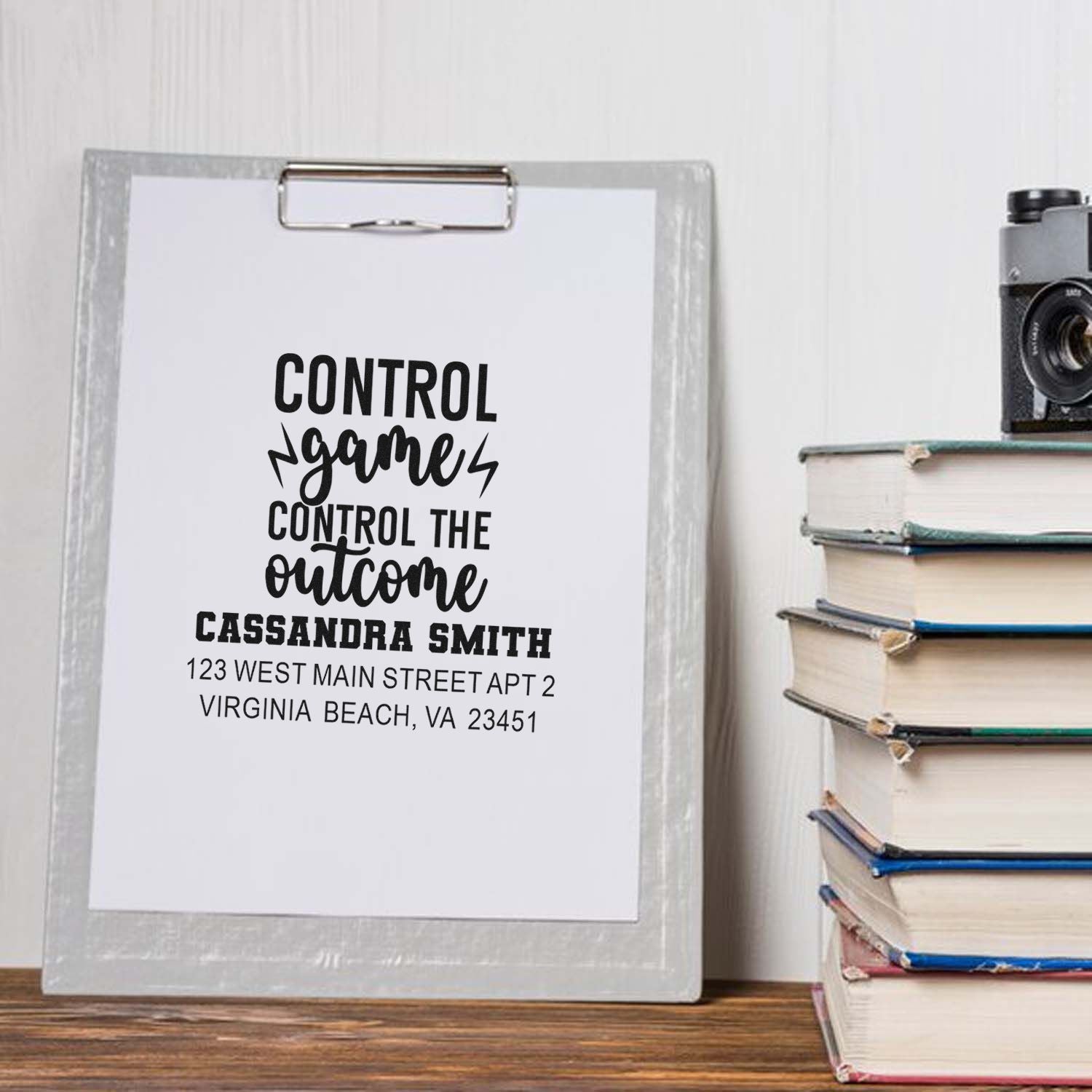 Personalized rubber stamp mockup with motivational quote, name, and return address for custom address stamping.