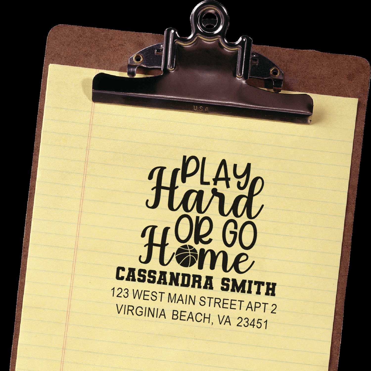 Custom address rubber stamp with Play Hard or Go Home slogan, name, and address on a clipboard.