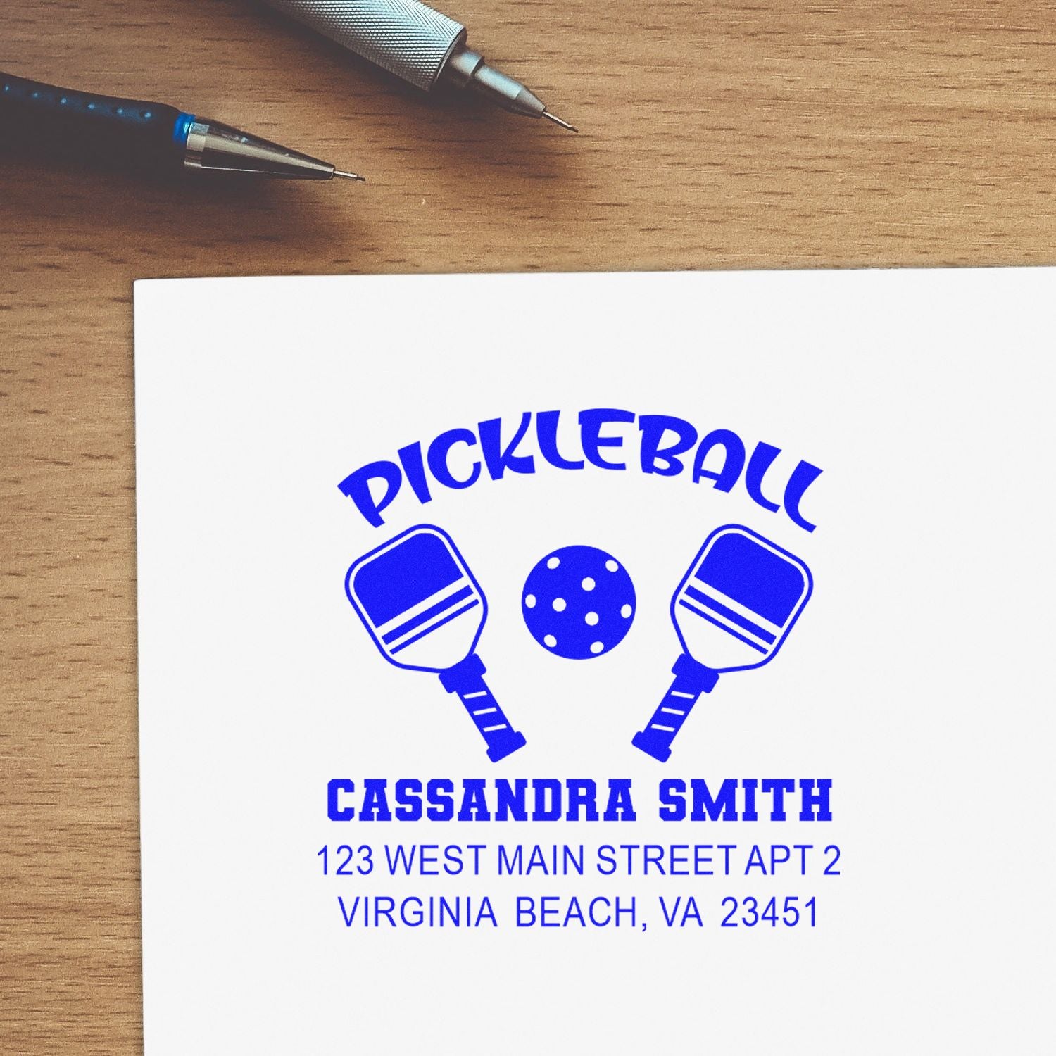 Personalized pickleball rubber stamp design with paddles, ball, name and address for custom mailing or packaging.