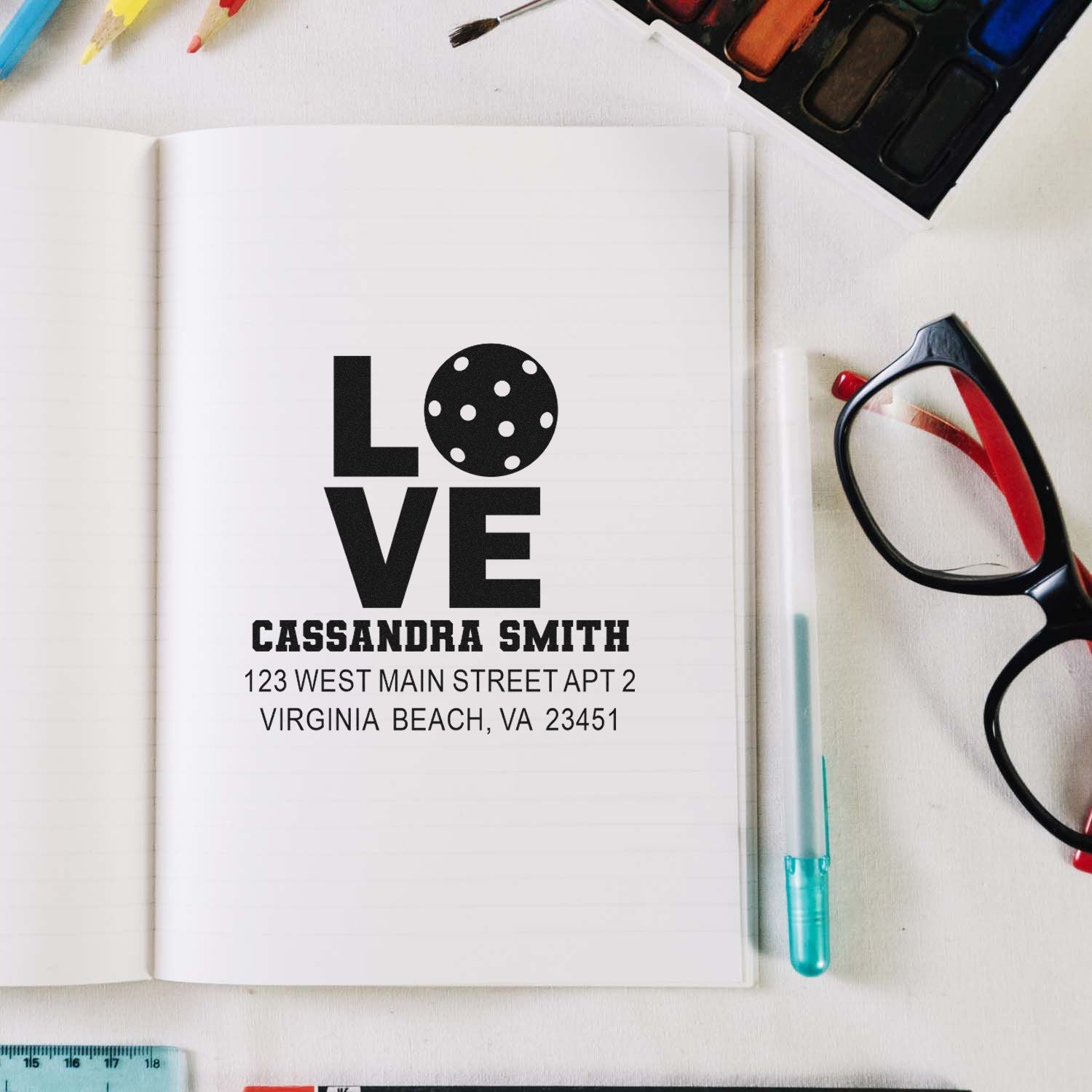 Custom LOVE rubber stamp with name and address on notebook page, ideal for personal stationery or wedding envelopes.
