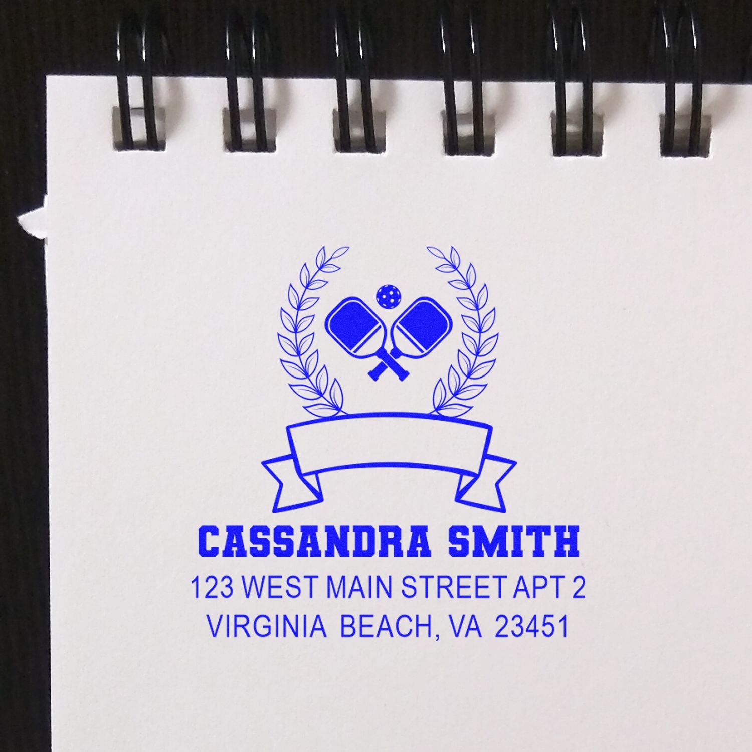 Custom rubber address stamp for Cassandra Smith, featuring pickleball paddles, wreath logo, and Virginia Beach, VA return address.