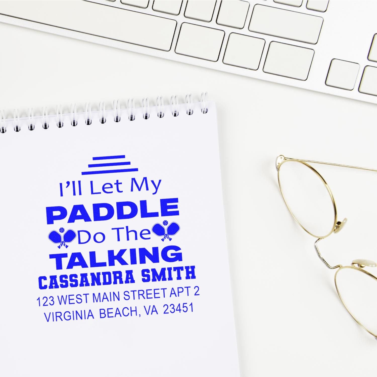 Custom address rubber stamp with Ill Let My Paddle Do the Talking design on notebook, ideal for personalized mail and gifts.