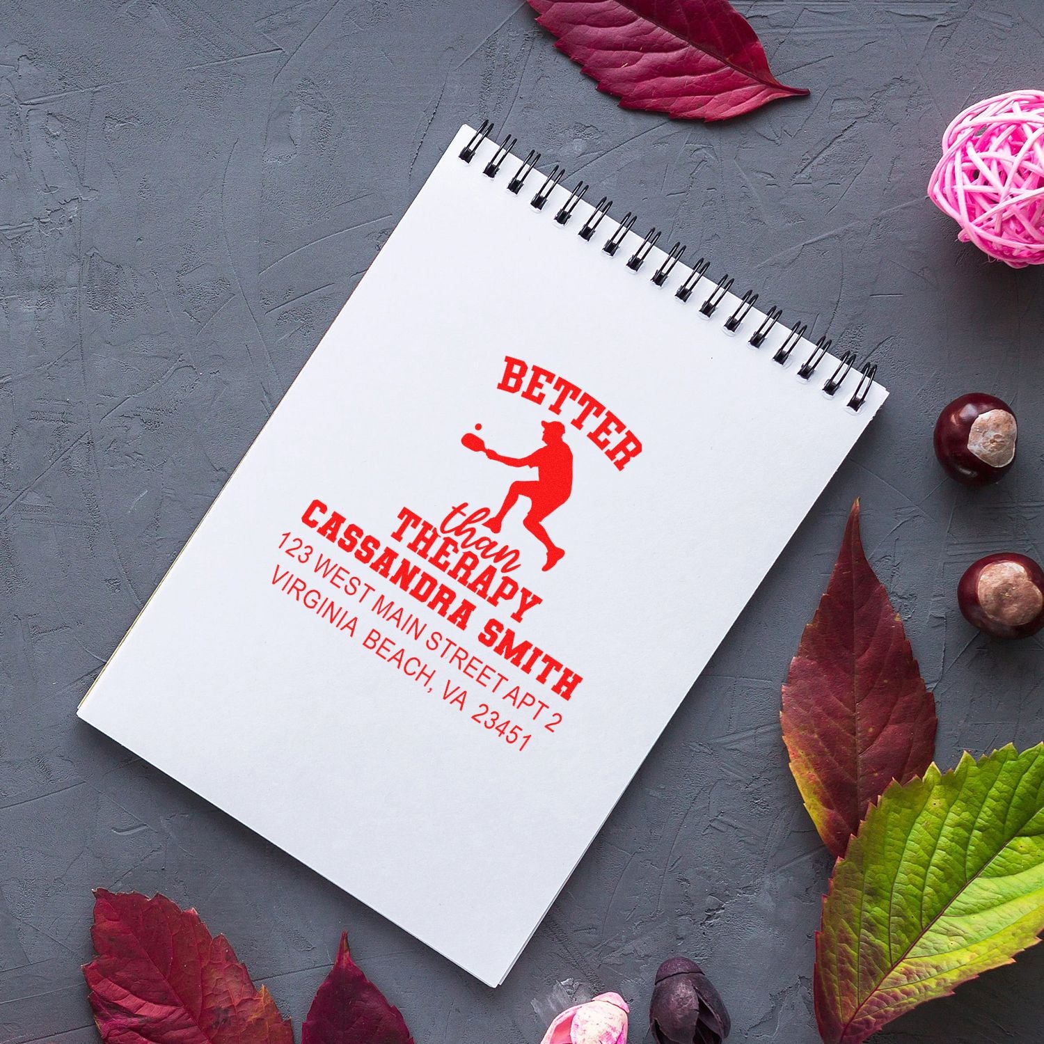 Custom rubber address stamp imprint reading Better than Therapy with Cassandra Smith return address on a notebook.