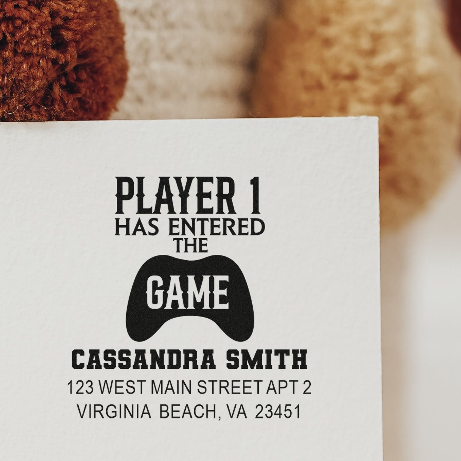 Custom rubber return address stamp for gamers reading Player 1 Has Entered the Game with personalized name and address.