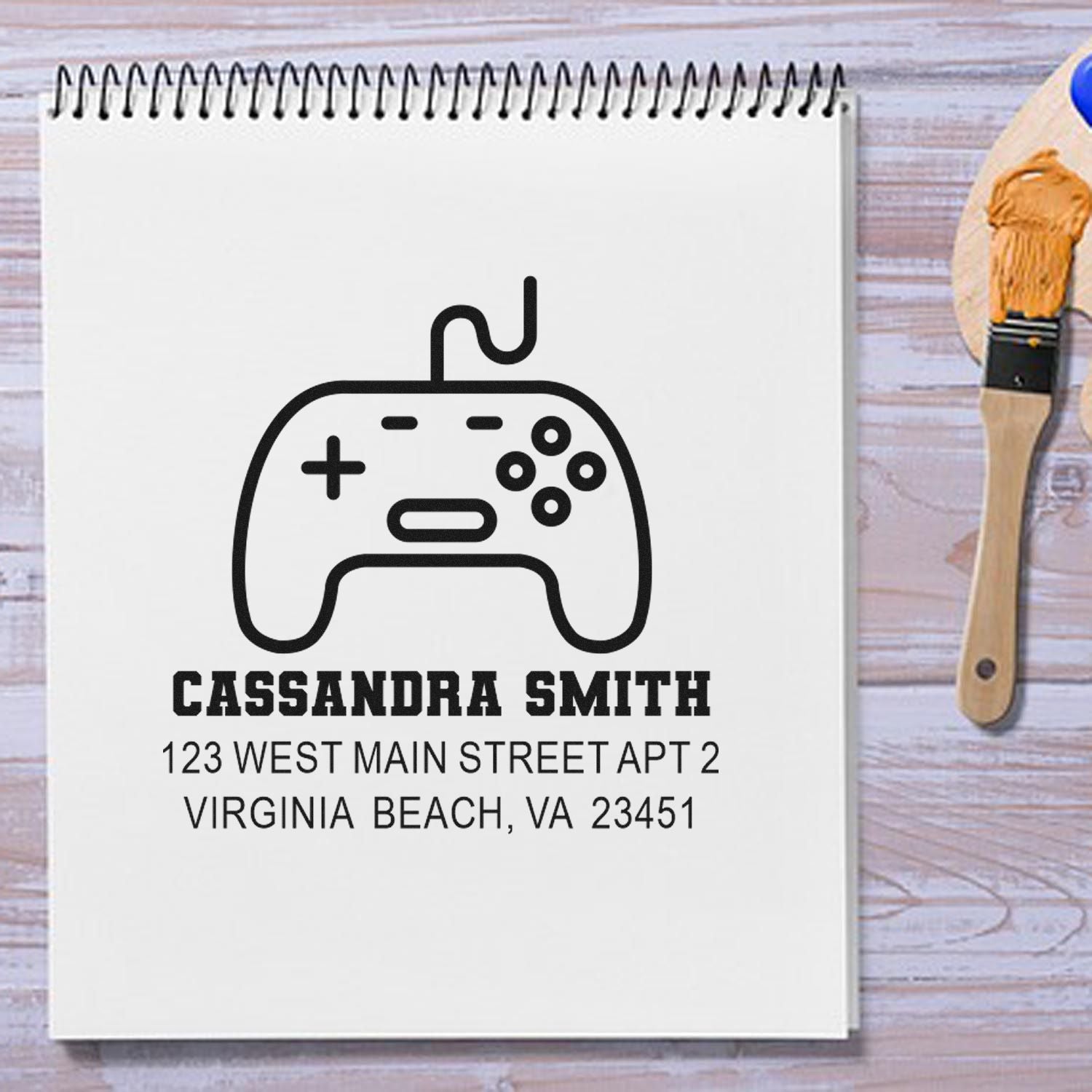 Custom return address rubber stamp with gamer controller icon, Cassandra Smith, and Virginia Beach address.