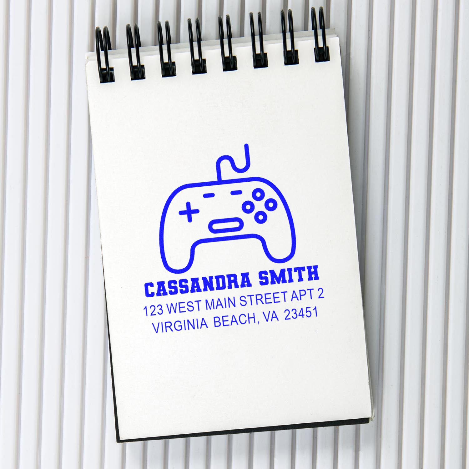 Personalized rubber address stamp with game controller logo for Cassandra Smith, Virginia Beach, VA return mail.