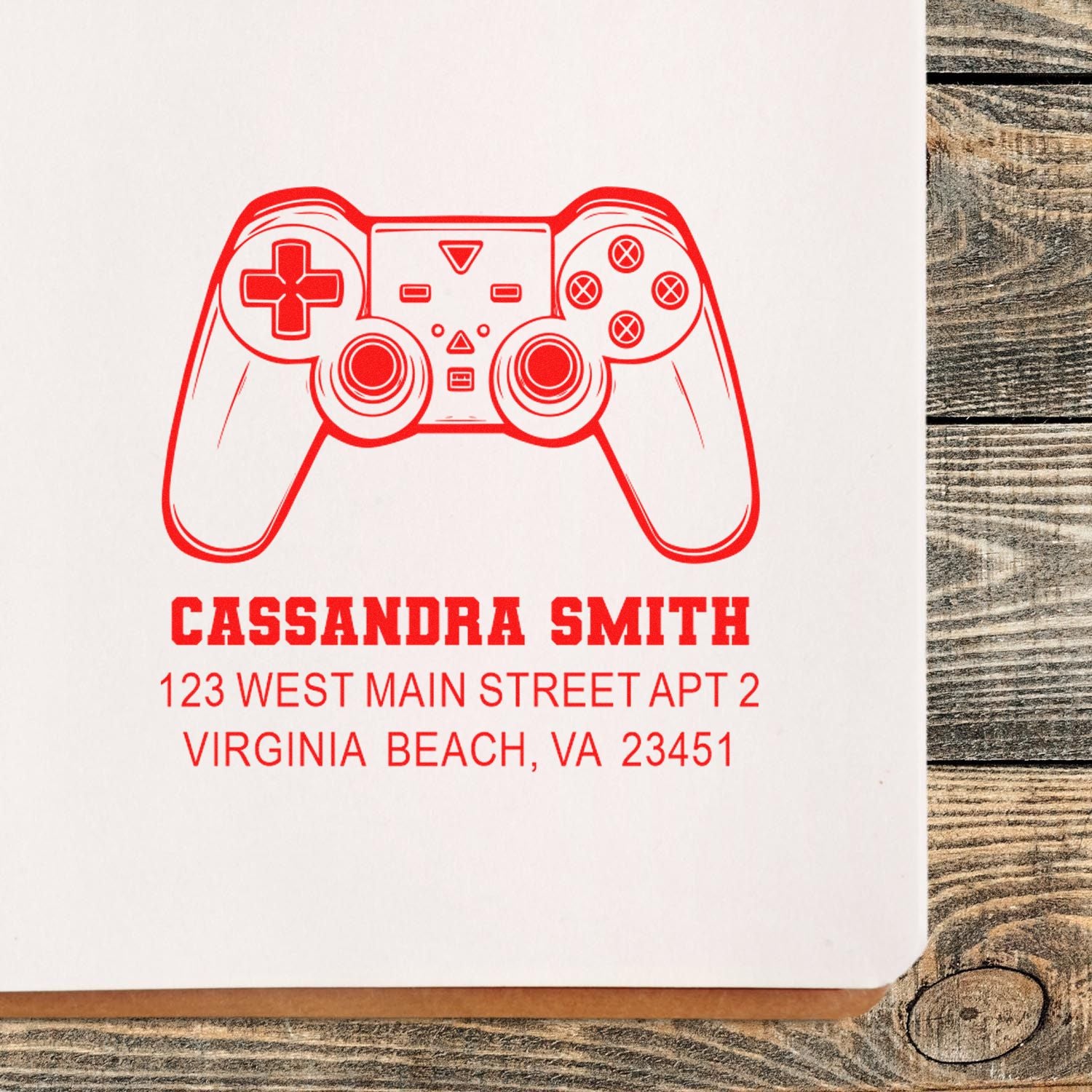 Personalized rubber address stamp with game controller design, Cassandra Smith name, and Virginia Beach return address.