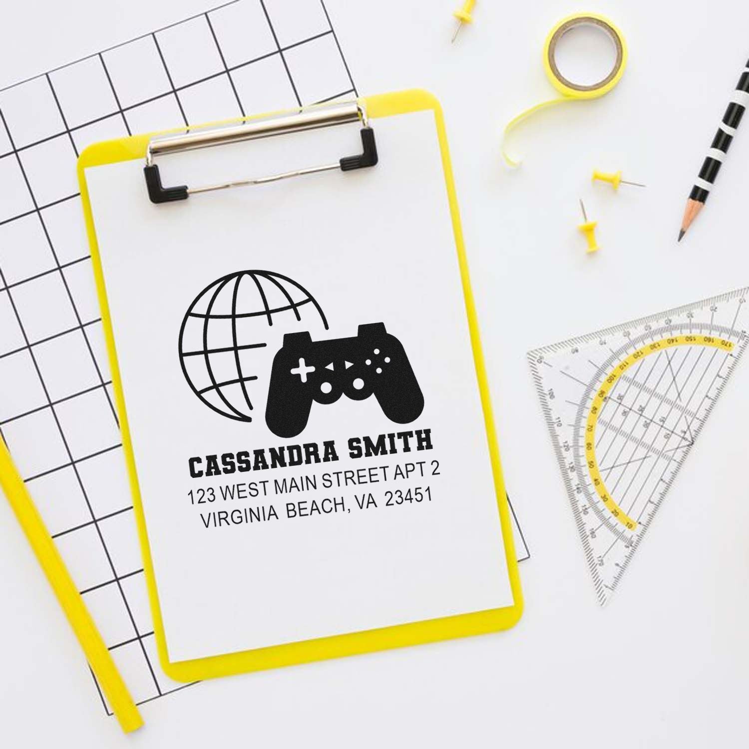 Custom rubber address stamp with gamer globe design, name and address, ideal for personalized mailing and branding.