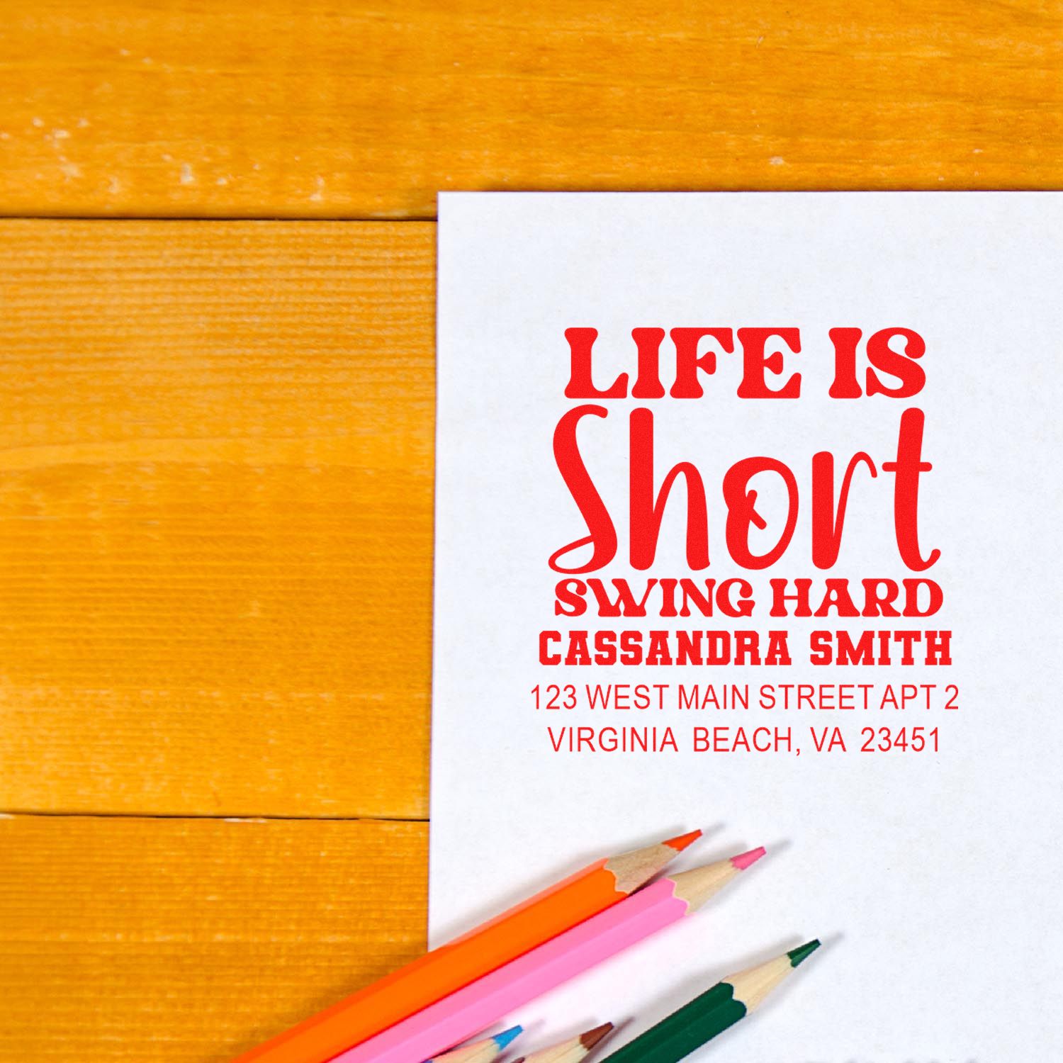 Custom rubber stamp return address stamp with bold red Life Is Short design, name, and Virginia Beach address on white paper.