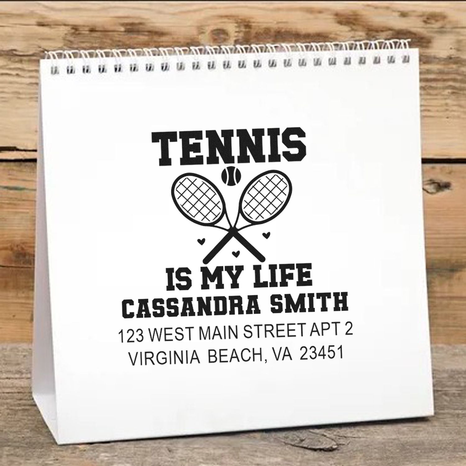 Custom tennis rubber stamp design with crossed rackets, personalized name, and address for gift bags or stationery.
