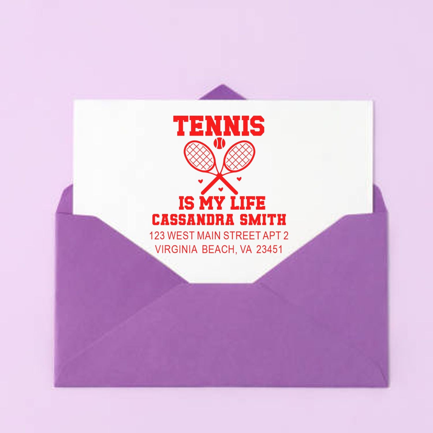 Custom tennis-themed address rubber stamp on envelope with name and return address for Cassandra Smith.