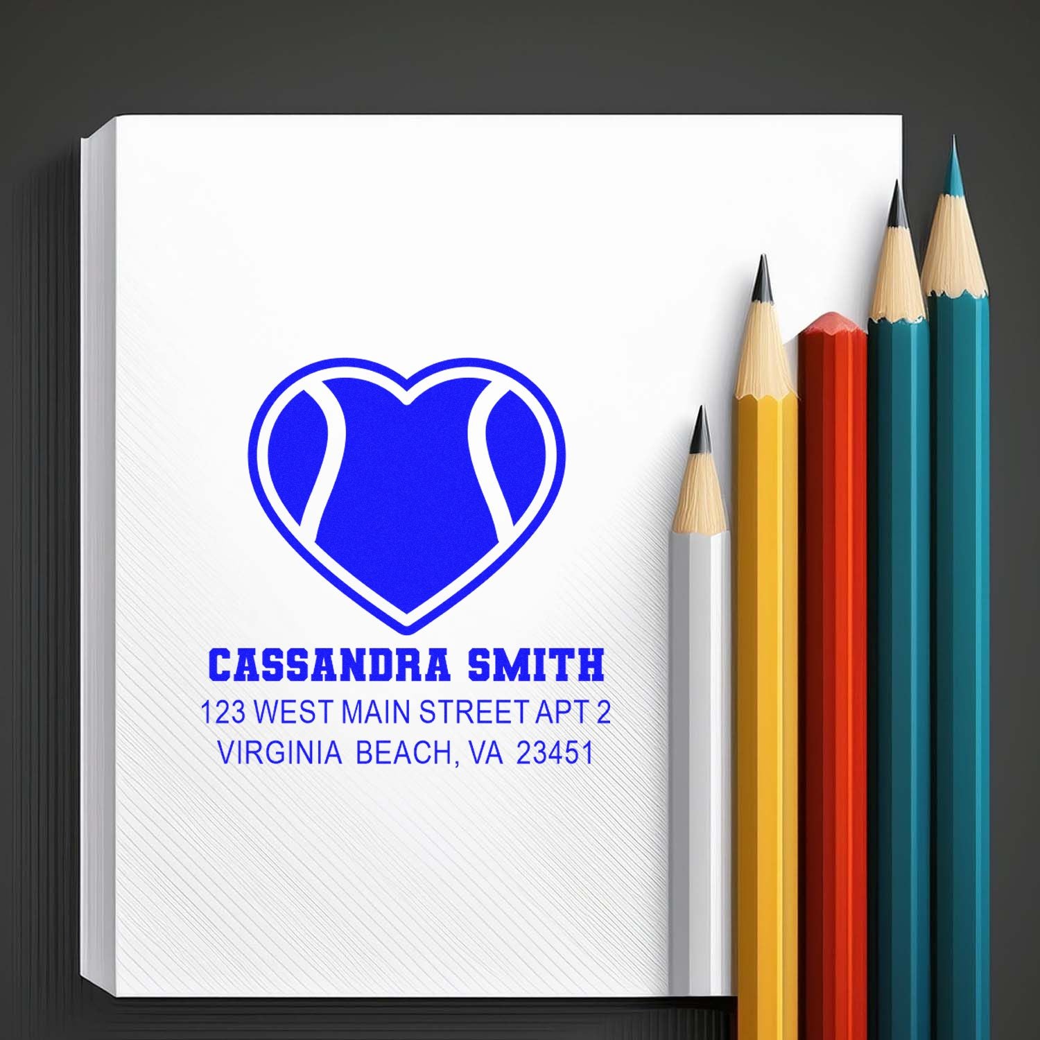 Custom rubber stamp return address design with heart logo, Cassandra Smith, and Virginia Beach address on notebook