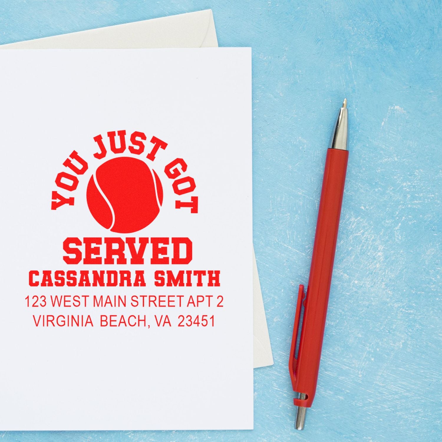 Personalized tennis-themed rubber stamp with You Just Got Served design and return address on envelope.