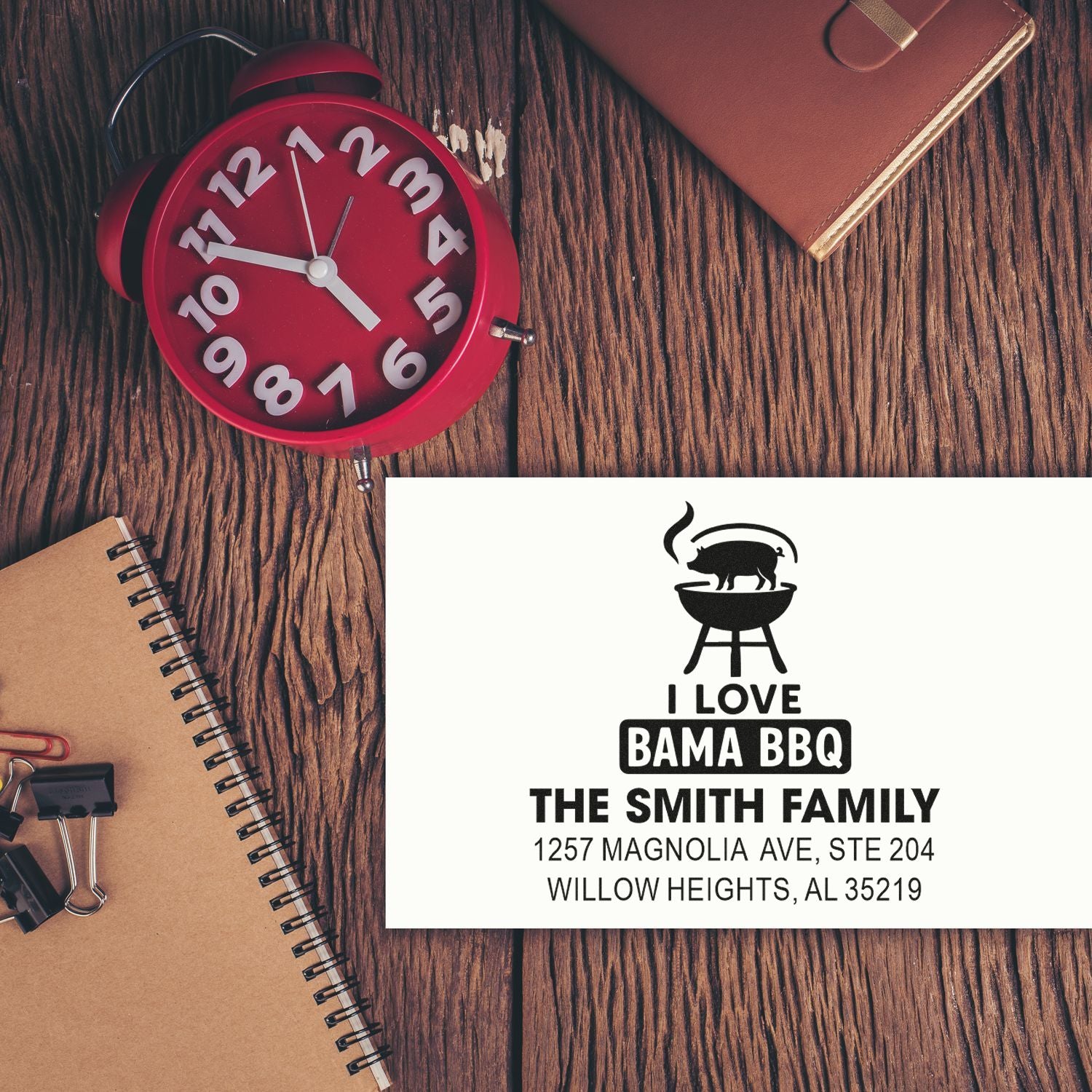 Personalized return address rubber stamp with BBQ logo, family name, and address for custom mailing and home use.