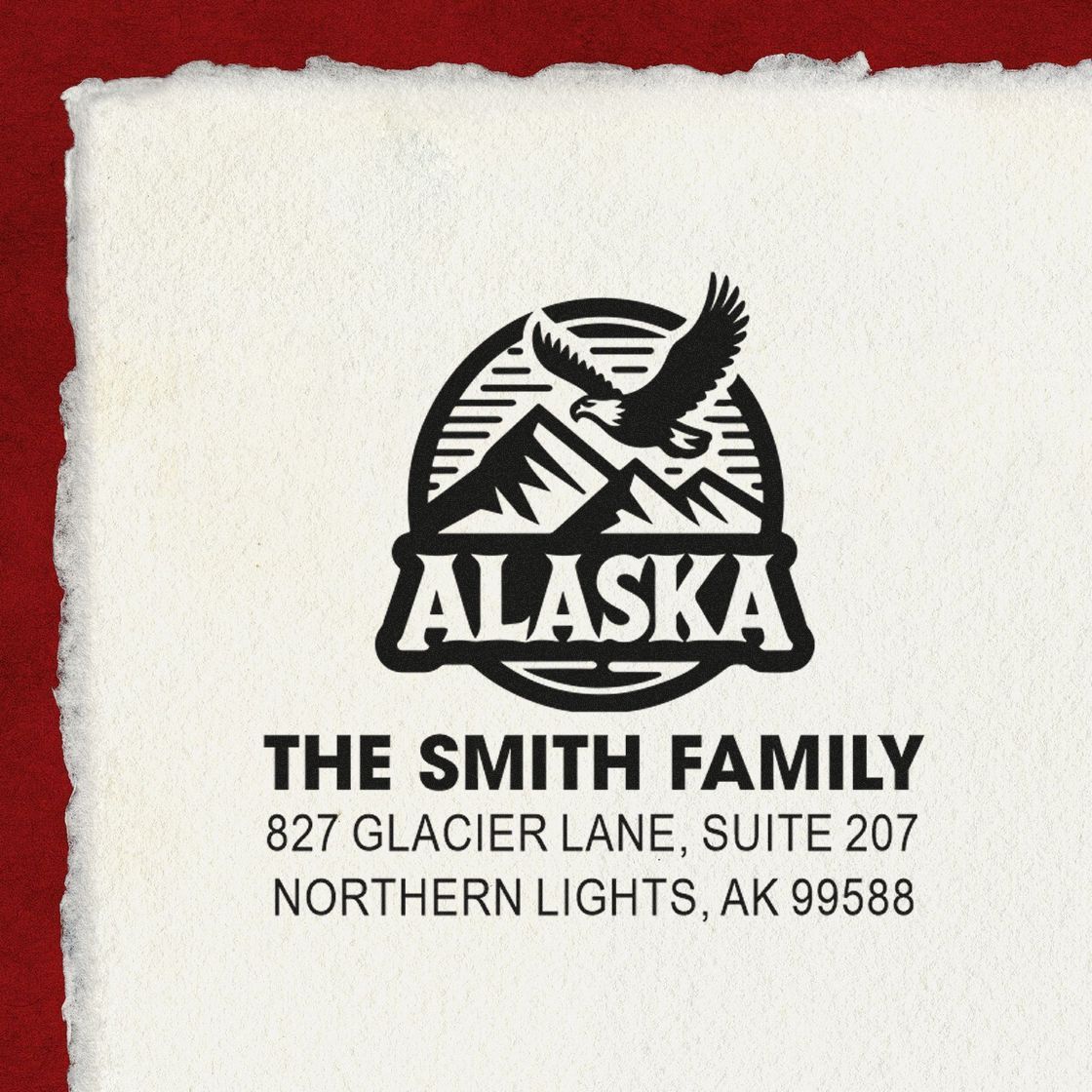 Custom Alaska rubber address stamp for The Smith Family, with eagle and mountain logo and return address in Northern Lights, AK.
