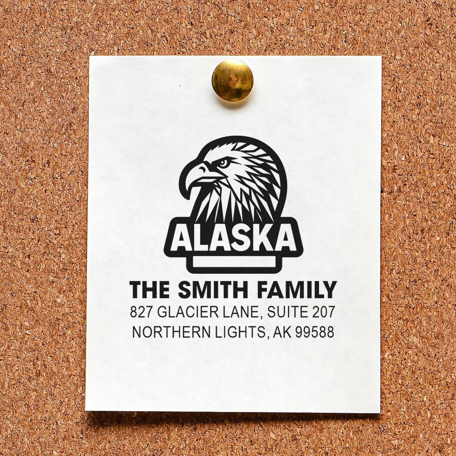 Custom Alaska address rubber stamp with eagle logo and family name, perfect for personalized envelopes and mailing.