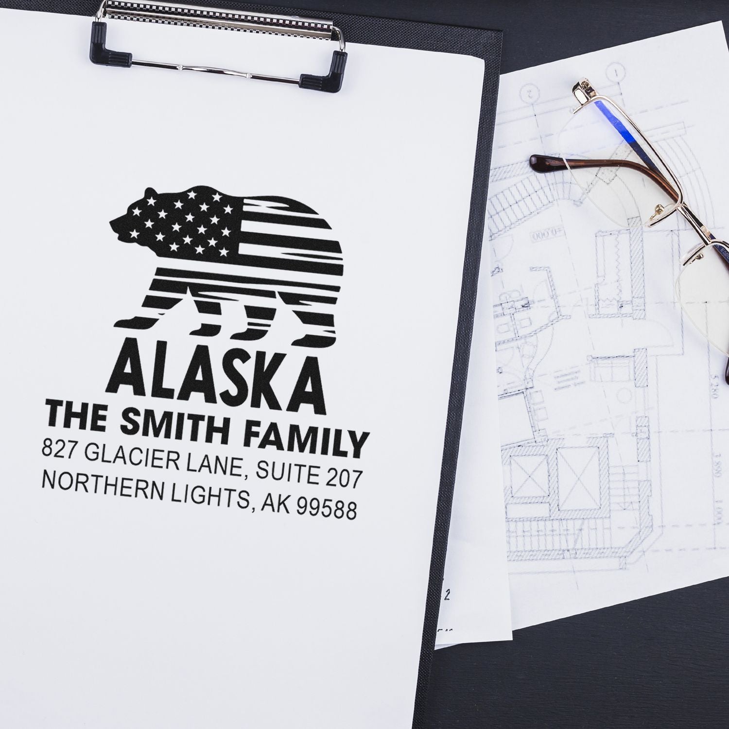 Custom Alaska return address rubber stamp with bear design, stamped on paper for mailing and family branding.