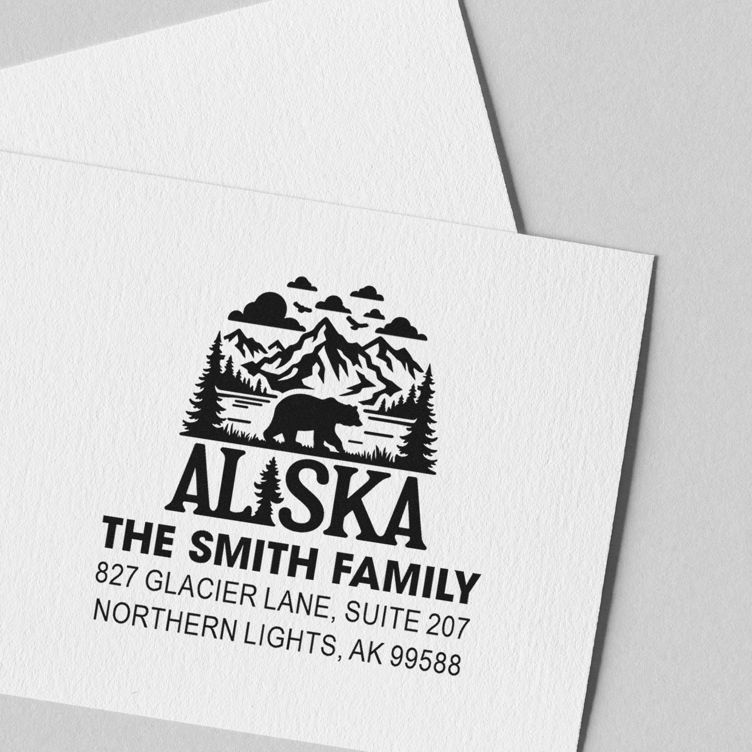 Personalized Alaska family return address rubber stamp with mountain, bear and pine tree design for envelopes.