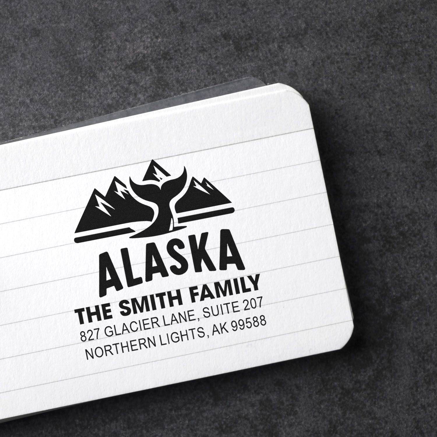 Custom Alaska family address rubber stamp with mountain logo for personalized mail and stationery.