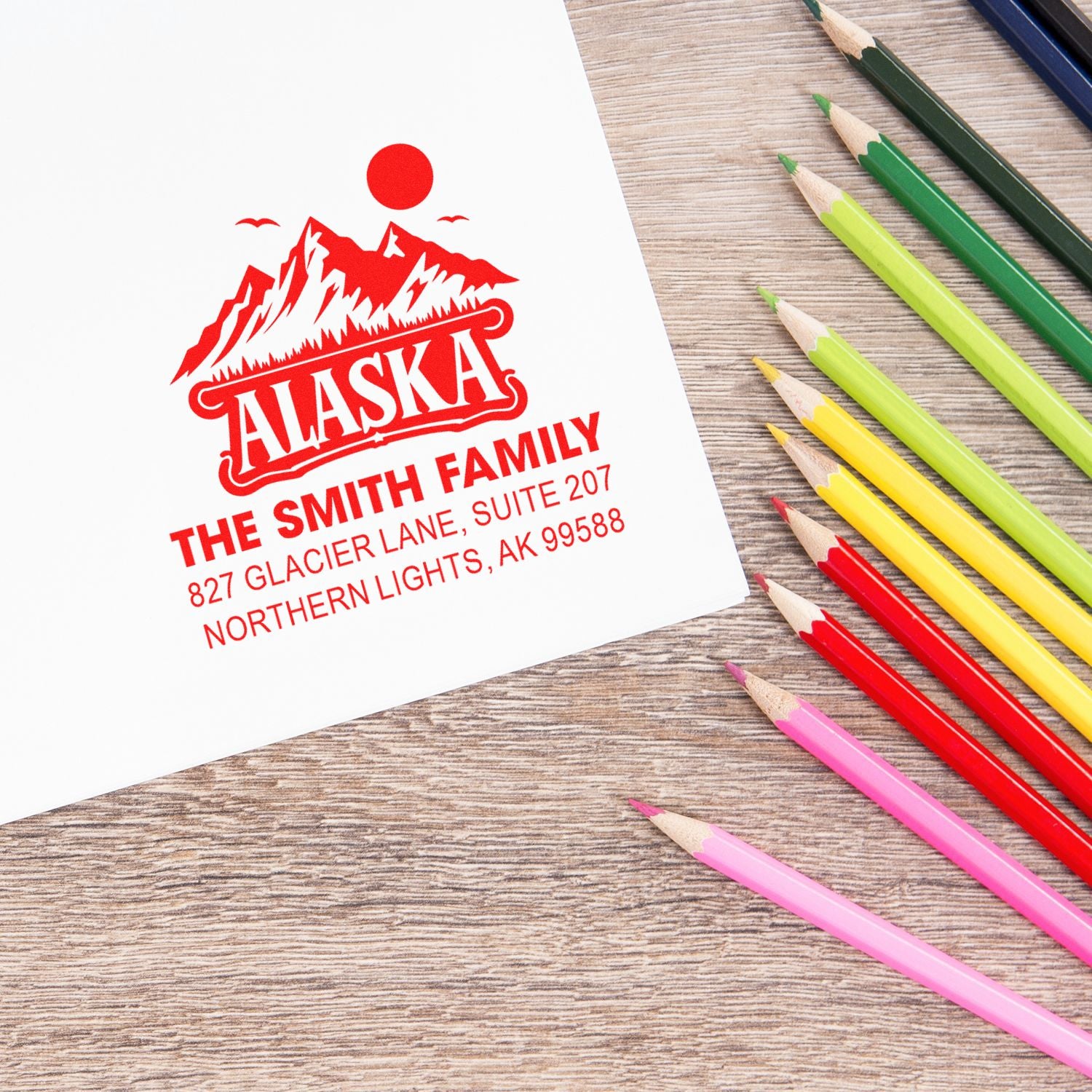 Custom Alaska family return address rubber stamp with mountain logo and address for personalized mail and envelopes.