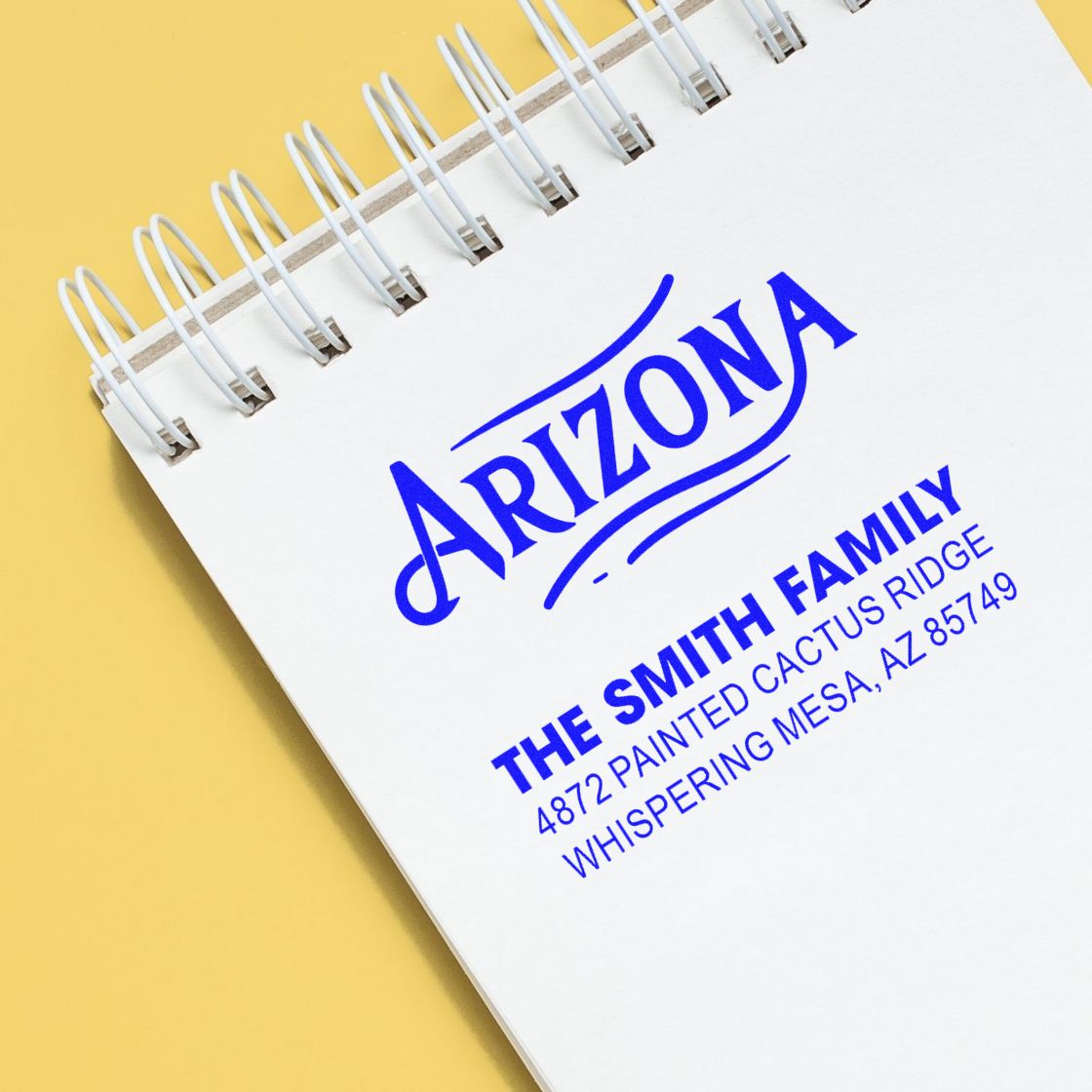 Personalized rubber address stamp for Arizona family mailing address on notebook page