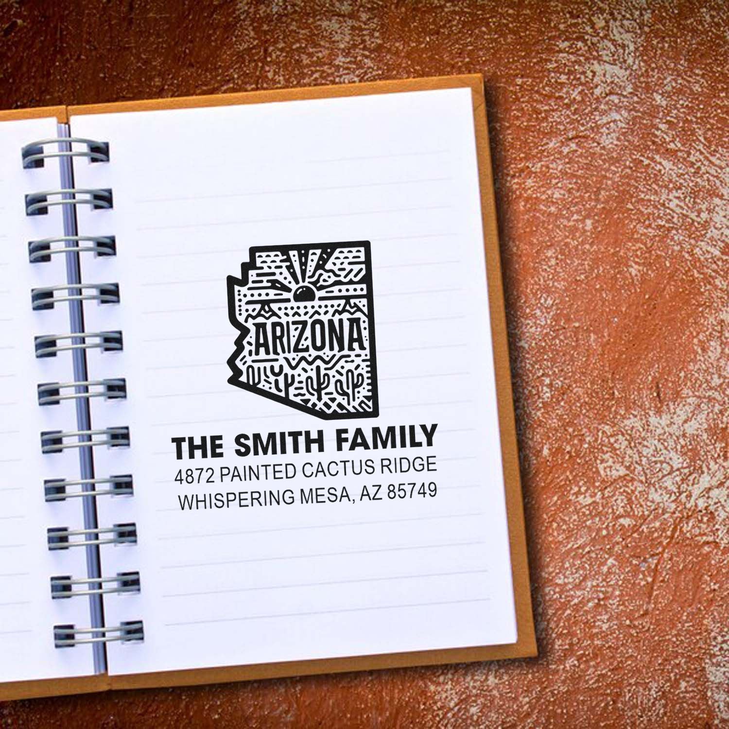 Custom Arizona return address rubber stamp with cactus design, stamped in a notebook for The Smith Family.