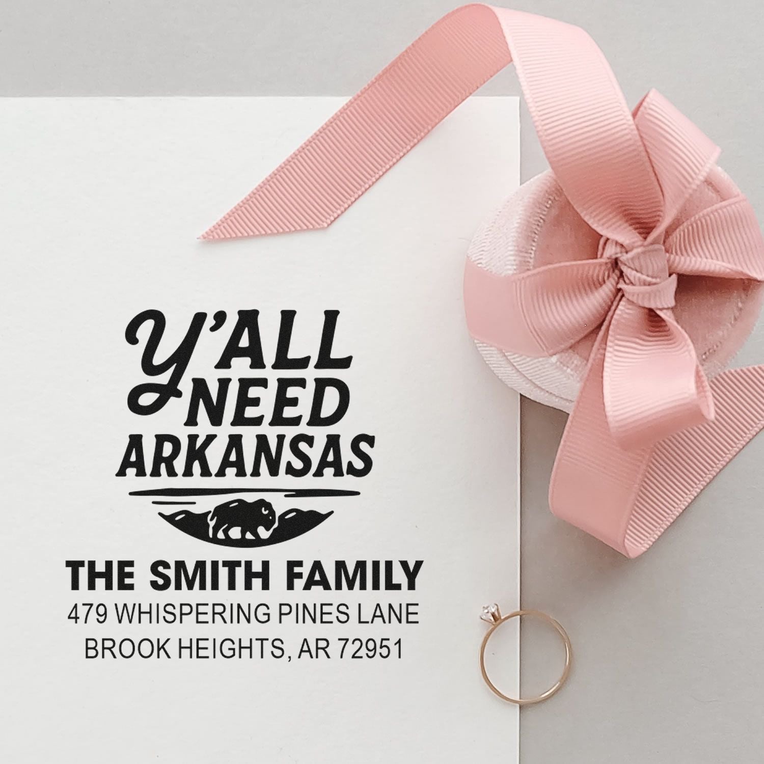 Custom return address rubber stamp for The Smith Family, featuring an Arkansas design on a gift envelope with pink ribbon.