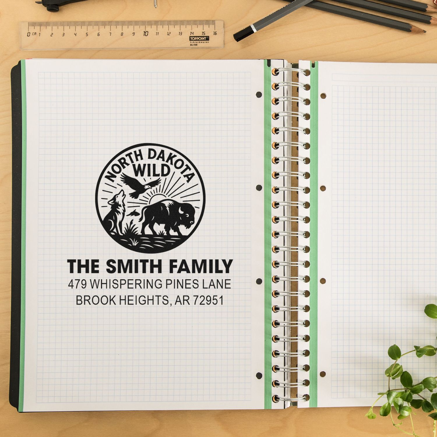 Personalized rubber address stamp with North Dakota wild design and The Smith Family return address on notebook paper.