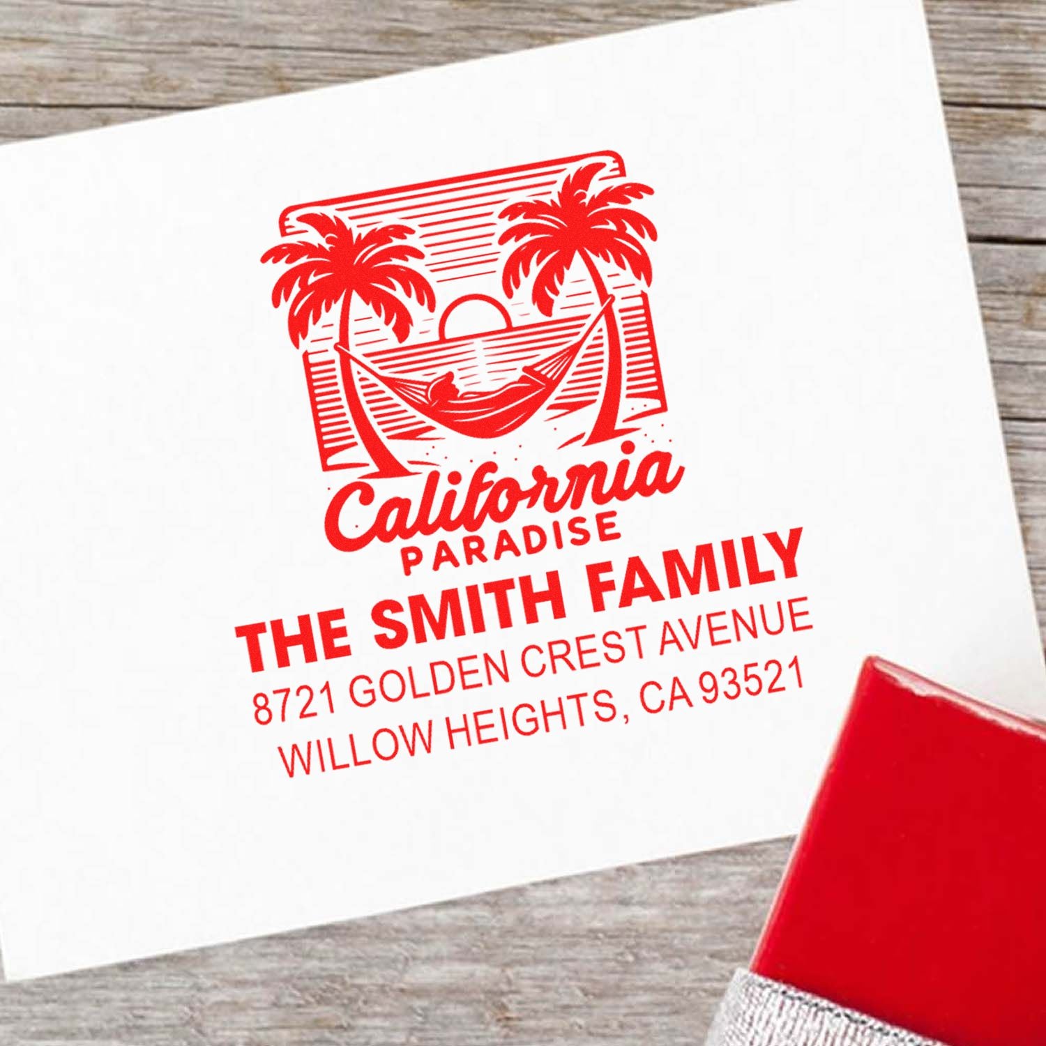 Custom rubber address stamp with California paradise palm tree design for The Smith Family, shown in red ink on paper.