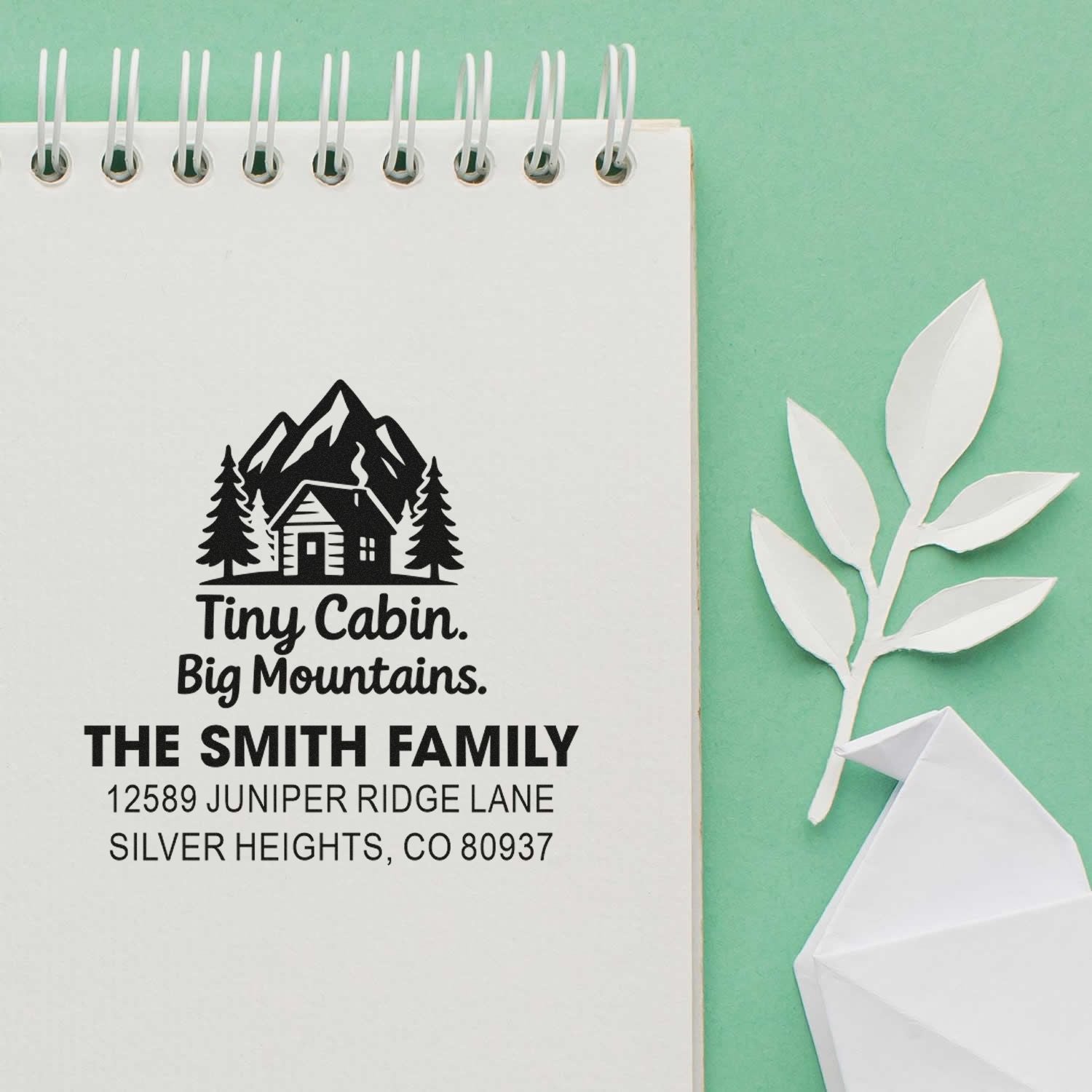 Personalized rubber stamp with cabin and mountain logo, featuring The Smith Family return address design.