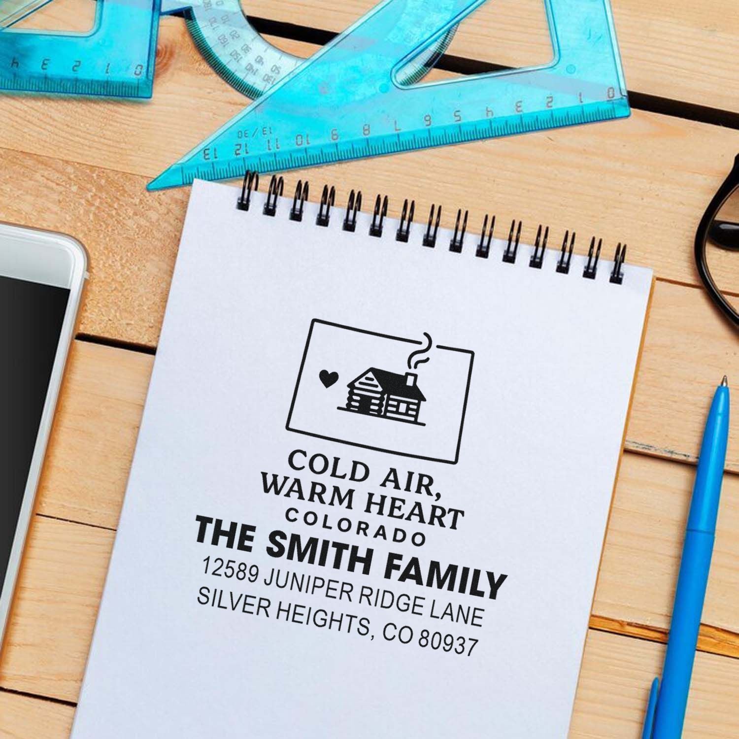 Custom return address rubber stamp mockup with Colorado family name and house icon for personalized mailings.
