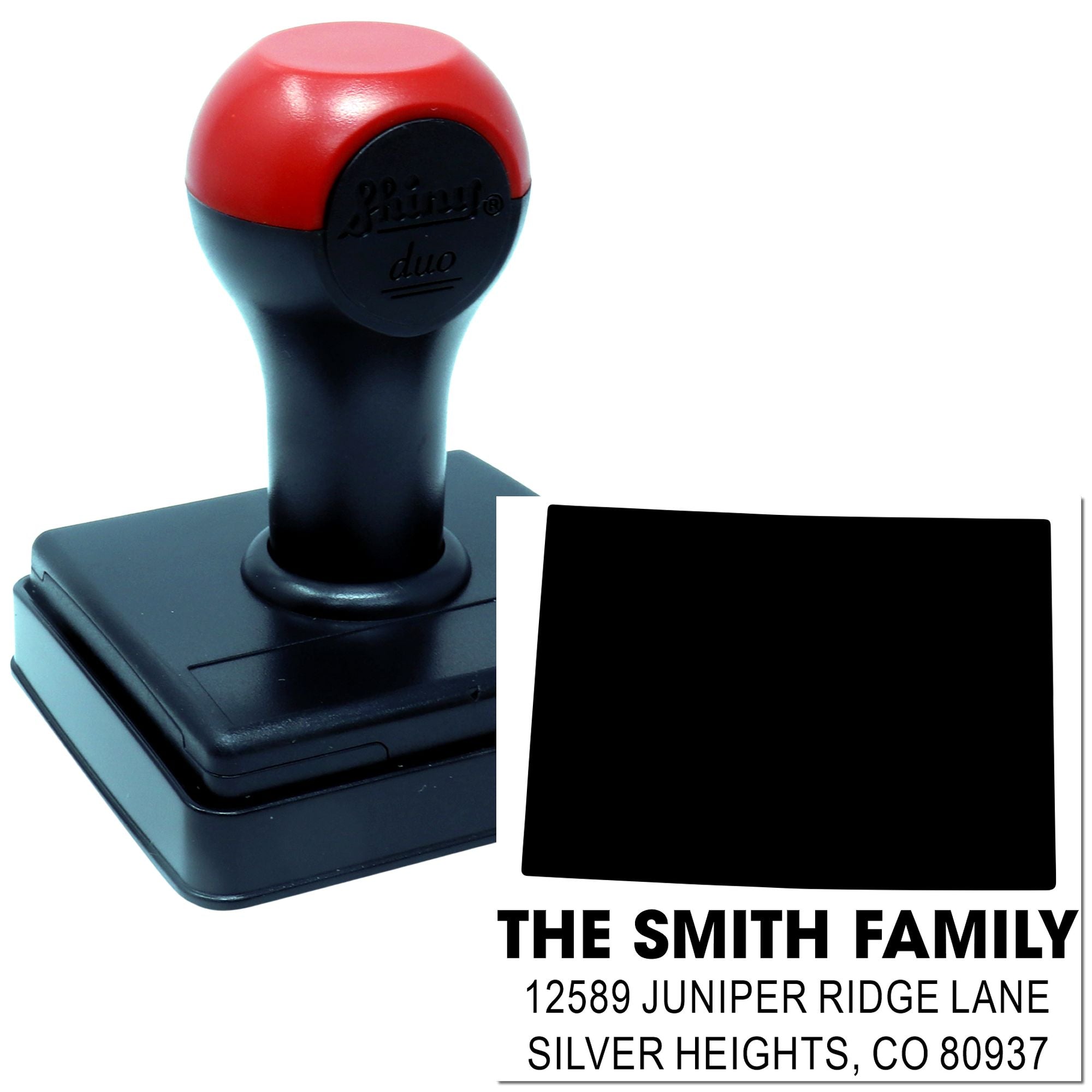 Custom self-inking rubber address stamp with family name and return address imprint for mail labeling.