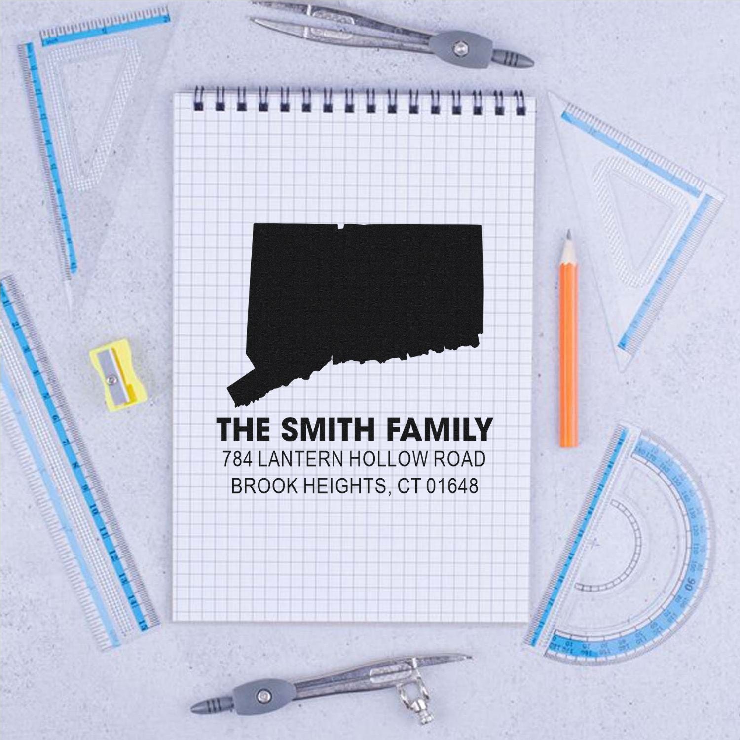 Custom rubber stamp design with Connecticut silhouette, family name, and address for personalized address stamping.