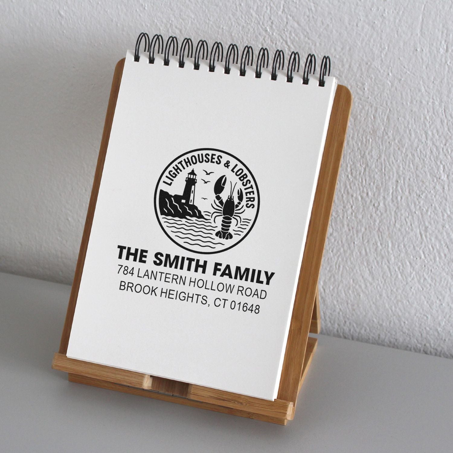 Custom return address rubber stamp with lighthouse and lobster design for The Smith Family, Brook Heights, CT.